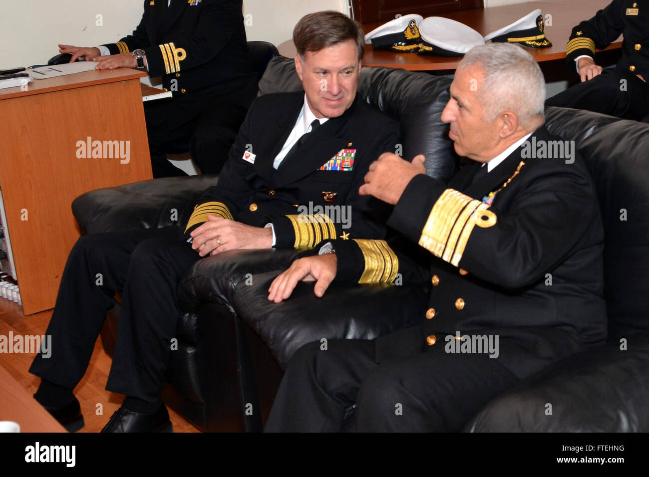 Adm. Mark Ferguson, commander, U.S. Naval Forces Europe-Africa, speaks with Vice Adm. Evangelos Apostolakis, Chief of the Hellenic Navy, during his visit to the Hellenic Naval Base Headquarters. Stock Photo