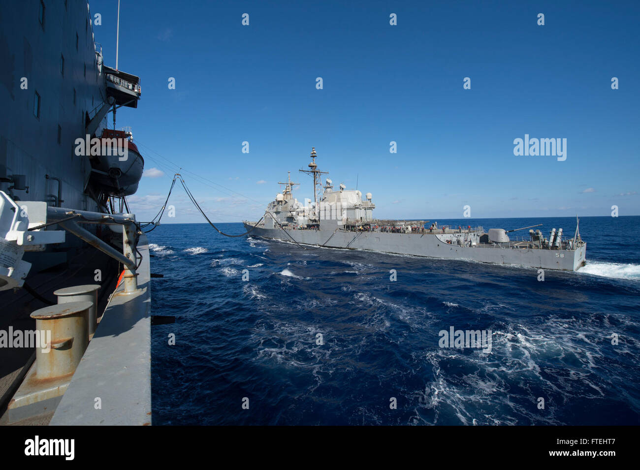 MEDITERRANEAN SEA (Oct. 28, 2014) – The Ticonderoga-class guided missile cruiser Philippine Sea (CG 58) receives fuel from the fleet replenishment oiler USNS Leroy Grumman (T-AO 195) during an underway replenishment-at-sea. Grumman, the Military Sealift Command Mediterranean Sea duty oiler, is forward-deployed to the U.S. 6th Fleet area of operations in support of national security interests in Europe and Africa. Stock Photo