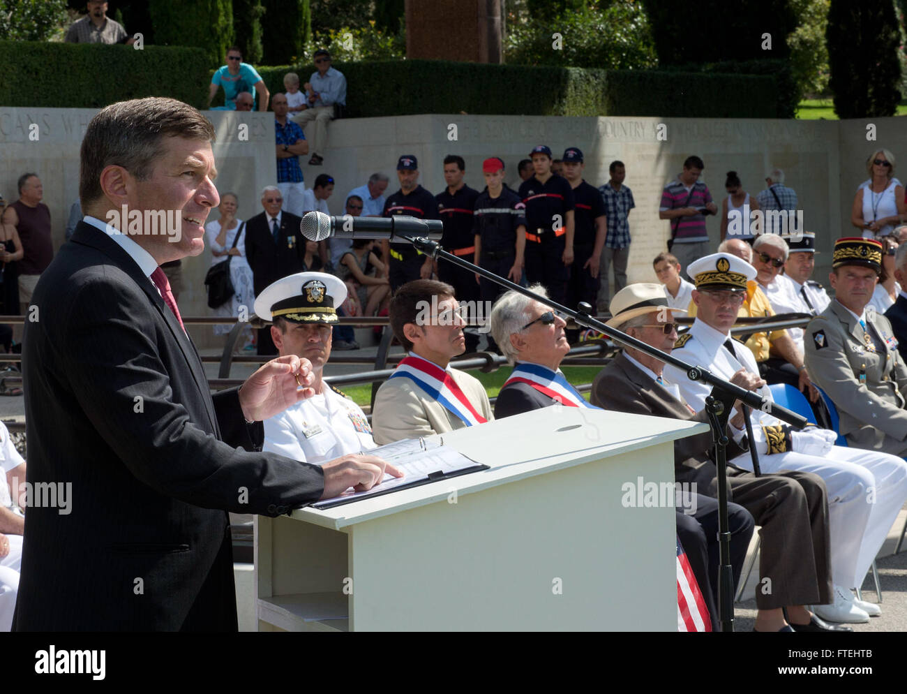 DRAGUIGNAN, France (August 16, 2013) – Charles Rivkin, left, United States Ambassador to France and Monaco, makes remarks during a ceremony at the Rhone American Cemetery in honor of the 69th anniversary celebration of allied troops landing in Provence during World War II. This visit serves to continue U.S. 6th Fleet efforts to build global maritime partnerships with European nations and improve maritime safety and security. Stock Photo