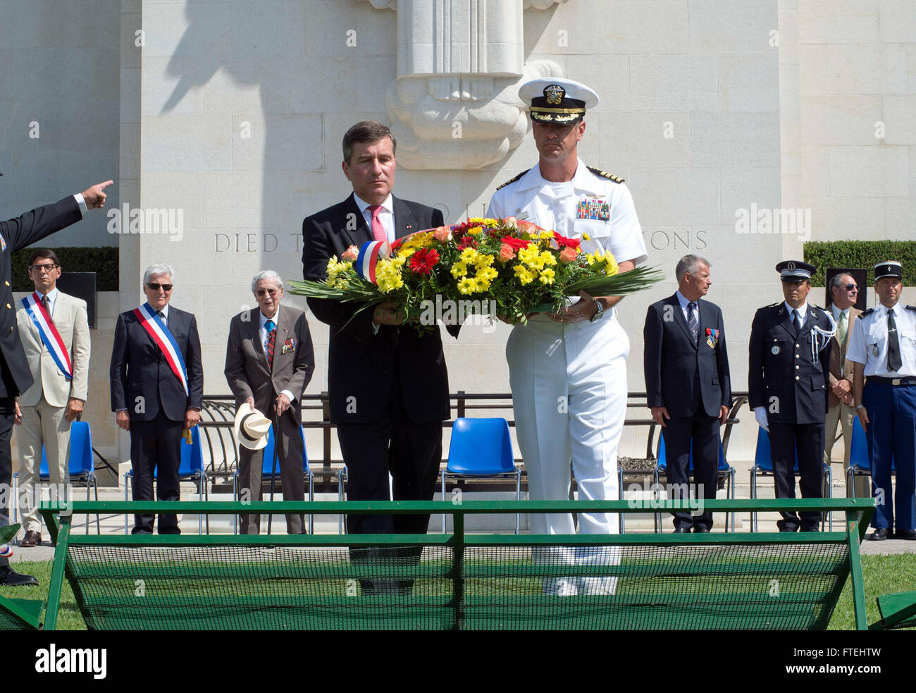 DRAGUIGNAN, France (August 16, 2013) – Charles Rivkin, left, United States Ambassador to France and Monaco and Capt. Craig Clapperton, USS Mount Whitney’s (LCC 20) commanding officer, lay a wreath during a ceremony at the Rhone American Cemetery in honor of the 69th anniversary celebration of allied troops landing in Provence during World War II. This visit serves to continue U.S. 6th Fleet efforts to build global maritime partnerships with European nations and improve maritime safety and security. Stock Photo