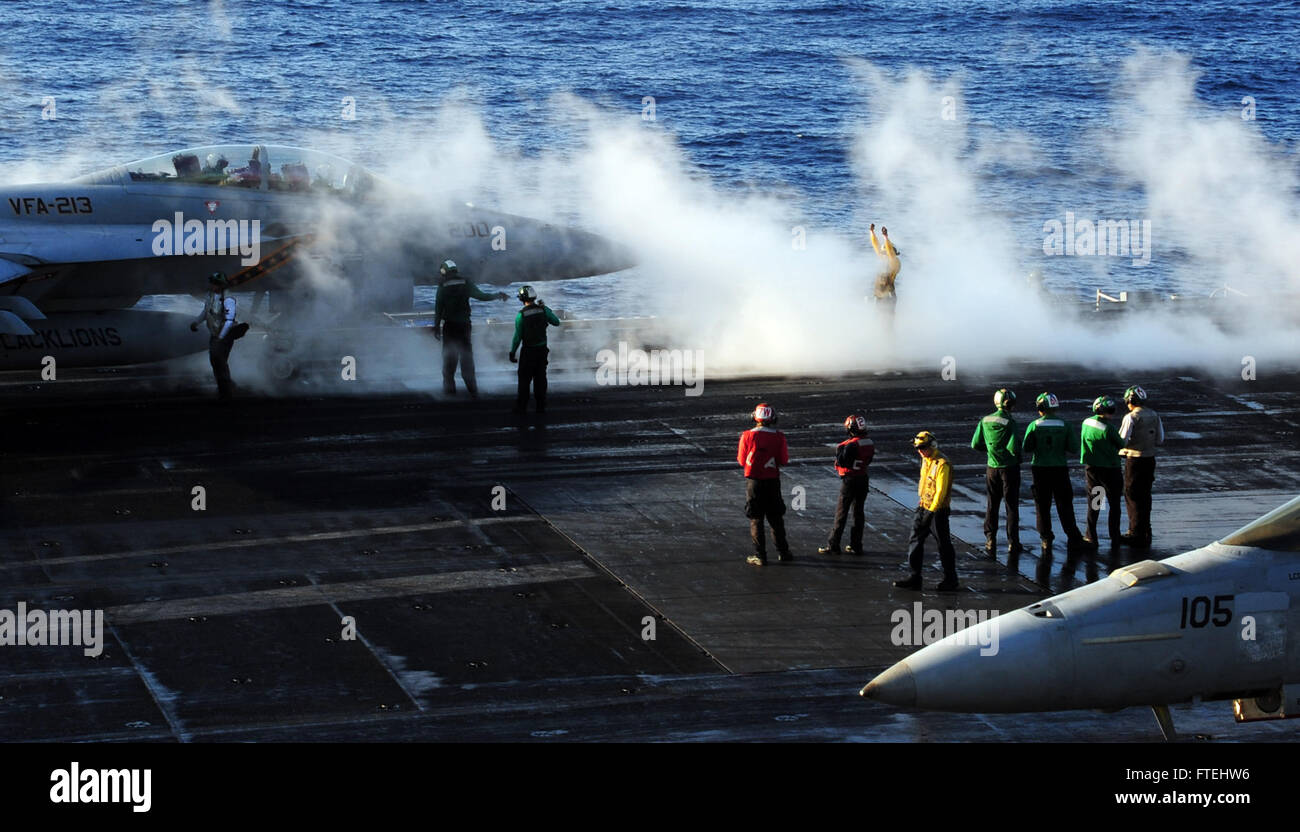 Aviation Boatswain's Mate 2nd Class Amanda White from Vandalia, Ohio, directs an F/A-18F Super Hornet on the flight deck of the USS George H.W. Bush (CVN 77). The aircraft carrier is operating in the Mediterranean Sea as part of U.S. naval operations supporting national security interests in Europe. Stock Photo