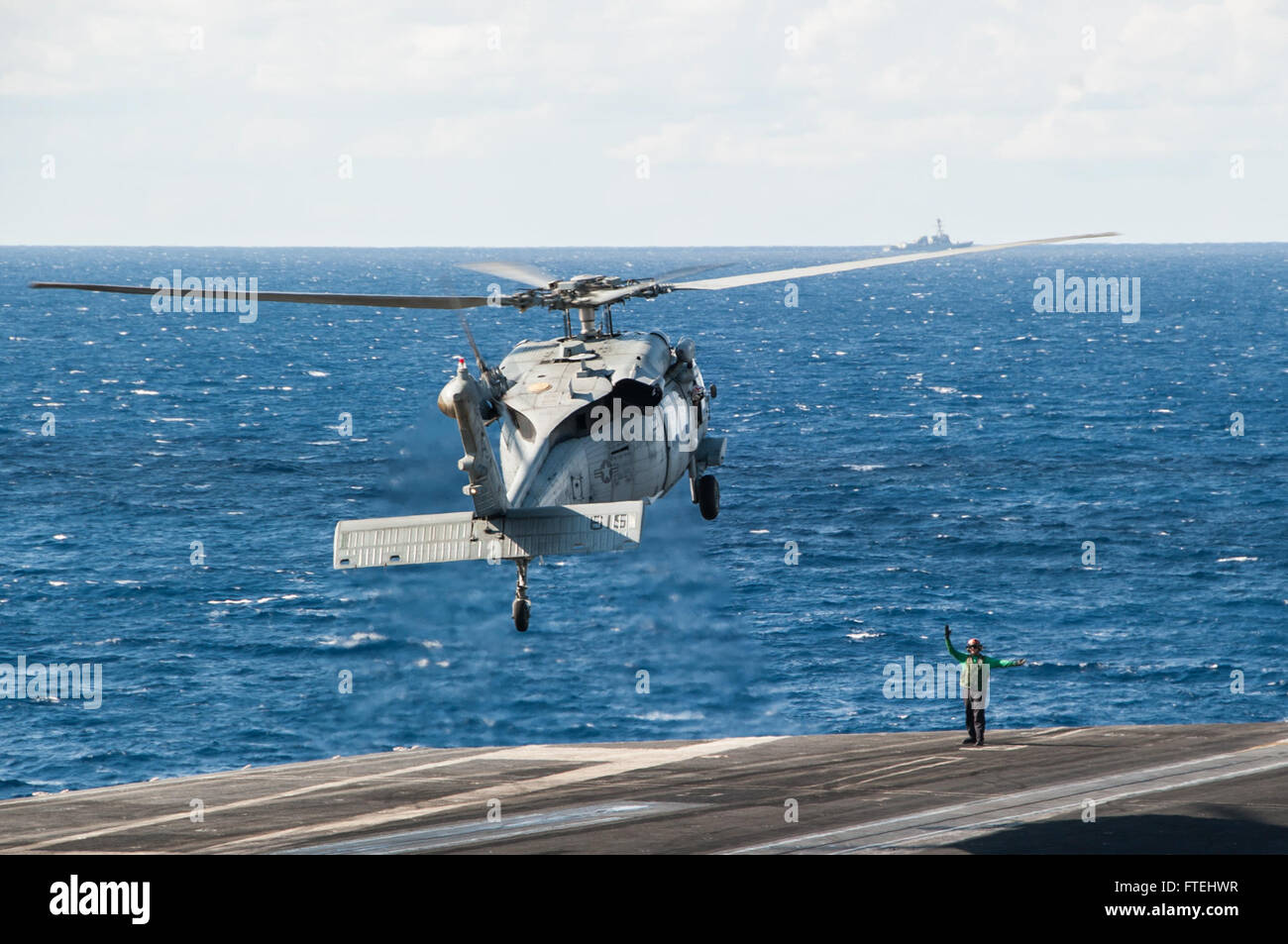 MEDITERRANEAN SEA (Oct. 29, 2014) An MH-60S Sea Hawk, attached to the &quot;Tridents&quot; of Helicopter Sea Combat Squadron (HSC) 9, lands on the flight deck of the aircraft carrier USS George H.W. Bush (CVN 77). George H.W. Bush, homeported in Norfolk, Va., is conducting naval operations in the U.S. 6th Fleet area of operations in support of U.S. national security interests in Europe. Stock Photo