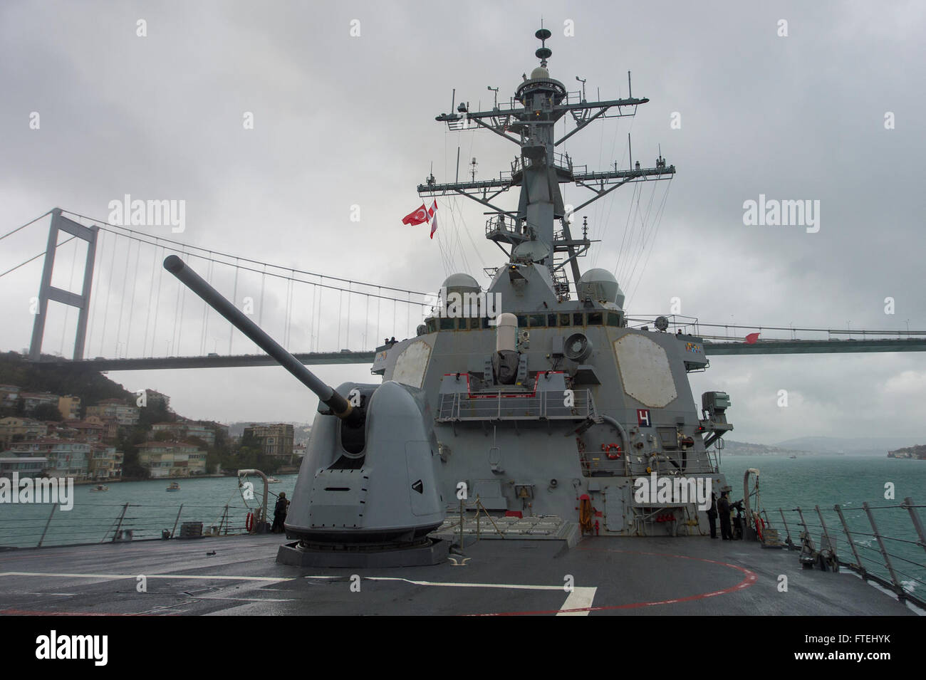 BOSPHORUS STRAIT (Oct. 30, 2014) – The Arleigh Burke-class guided-missile destroyer USS Cole (DDG 67) passes under the Fatih Sultan Mehmet bridge while transiting the Bosphorus Strait en route to the Aegean Sea. Cole, homeported in Norfolk, Va., is conducting naval operations in the U.S. 6th Fleet area of operations in support of U.S. national security interests in Europe Stock Photo