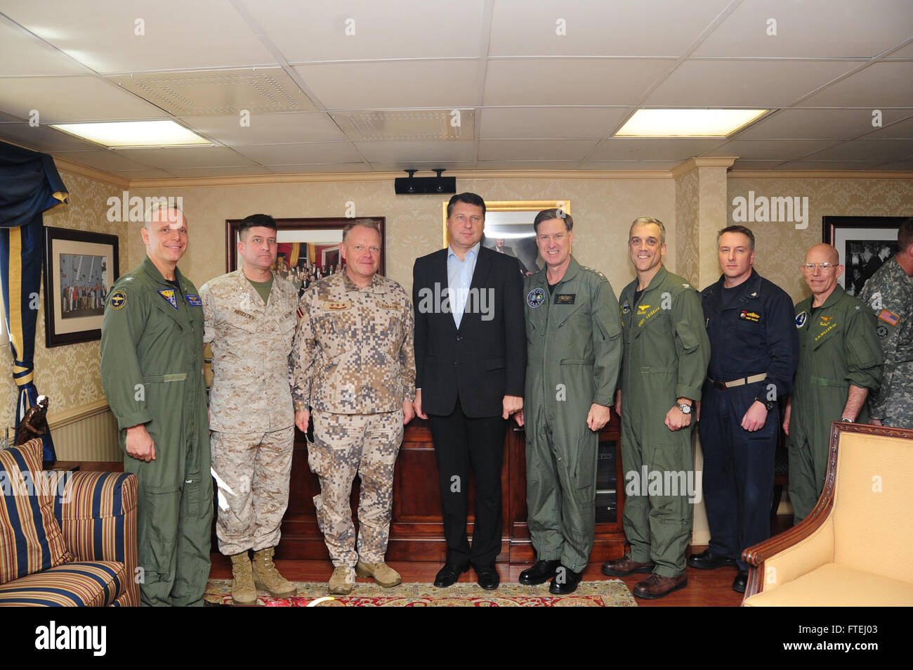 MEDITERRANEAN SEA (Oct. 30, 2014) ) From left to right, Capt. Daniel Cheever, commanding officer Carrier Airwing (CVW) 8; Lt. j.g. Raimonds Graube Latvian Chief of Defense; Lt. Cmdr. Philip Antekeir (US); Raimonds Vejonis, Latvian Chief of Defense; Adm. Mark Ferguson, commander of U.S. Naval Forces Europe-Africa, Capt. Andrew Loiselle, commanding officer USS George H.W. Bush (CVN 77); Capt. Robert Bodvake, Commodore Destroyer Squadron (DESRON) 22; and Rear Adm. DeWolfe Miller III, commander of Carrier Strike Group (CSG) 2, pose for a photo opportunity with a distinguished vi Stock Photo