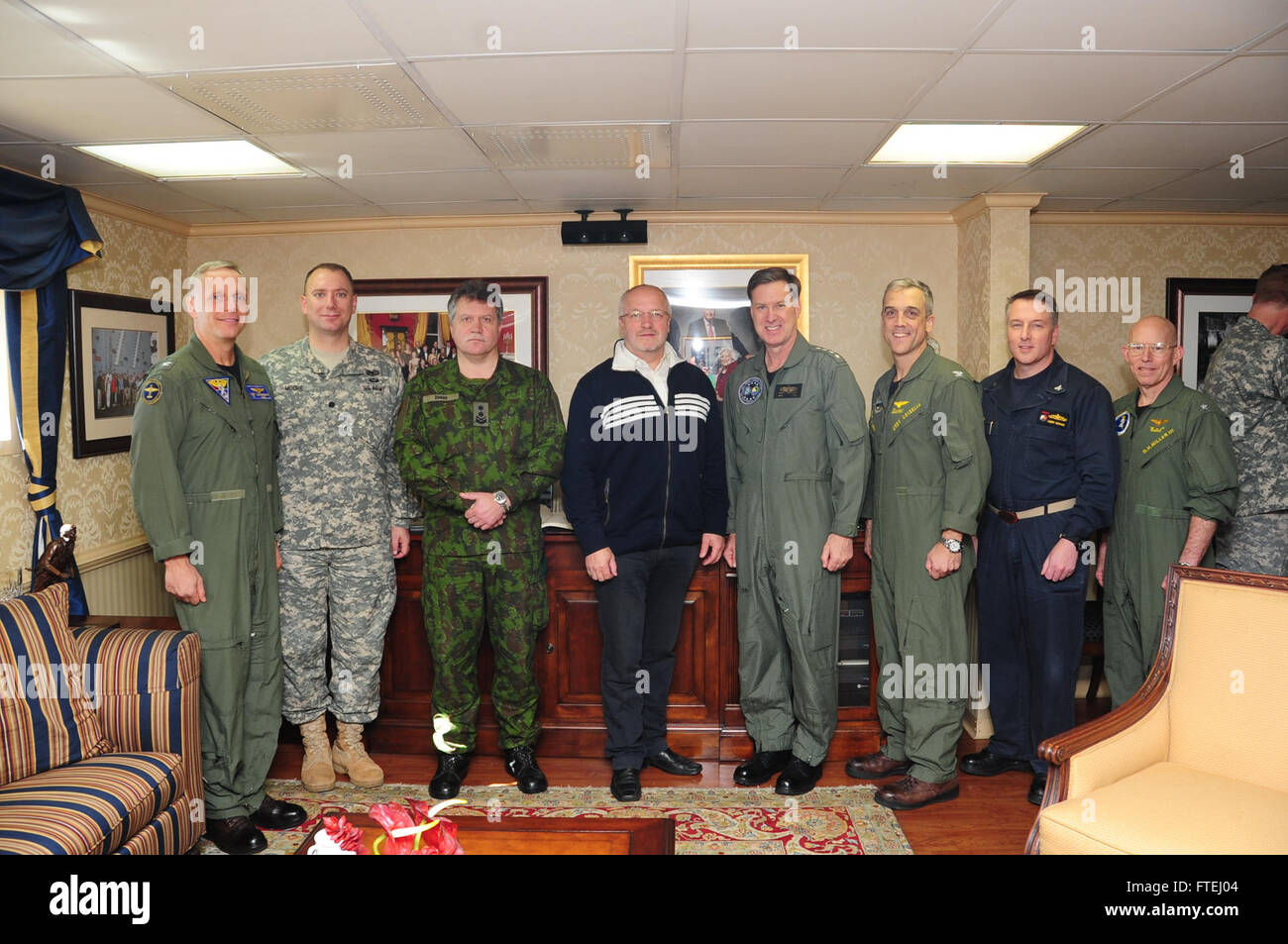 MEDITERRANEAN SEA (Oct. 30, 2014)  From left to right, Capt. Daniel Cheever commanding officer Carrier Airwing (CVW) 8; Lt. Cmdr. John Moore (US); Major Gen. Jonas Vyautas Zukas, Lithuanian Chief of Defense; Juozas Olekas, Lithuanian Minister of National Defense; Adm. Mark Ferguson, commander of U.S. Naval Forces Europe-Africa, Capt. Andrew Loiselle, commanding officer USS George H.W. Bush (CVN 77); Capt. Robert Bodvake, Commodore Destroyer Squadron (DESRON) 22; and Rear Adm. DeWolfe Miller III, commander of Carrier Strike Group (CSG) 2, pose for a photo opportunity with a d Stock Photo