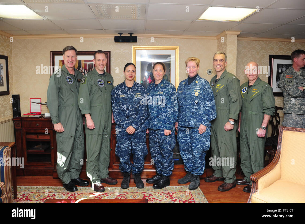 MEDITERRANEAN SEA (Oct. 30, 2014) From left to right, Adm. Mark Ferguson, commander of U.S. Naval Forces Europe-Africa Capt. Mark Imblum, Lt. Z’hra Ghavam, Lt. Cmdr. Jaime Davis, Fleet Master Chief Jo Ann Ortloff, Capt. Andrew Loiselle, commanding officer, USS George H.W. Bush (CVN 77); Capt. Robert Bodvake Commodore Destroyer Squadron (DESRON) 22; and Rear Adm. DeWolfe Miller III commander of Carrier Strike Group (CSG) 2, pose for a photo opportunity with a distinguished visitors group aboard the aircraft carrier USS George H.W. Bush (CVN 77). George H.W. Bush, homeported i Stock Photo