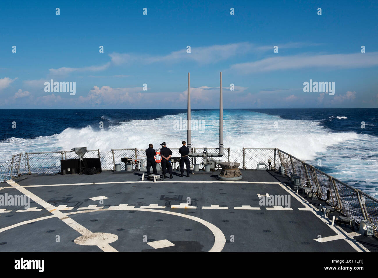 MEDITERRANEAN SEA (Oct. 29, 2014) – Sailors look at the wake from the Arleigh Burke-class guided-missile destroyer USS Ross (DDG 71). Ross, homeported in Rota, Spain, is conducting naval operations in the U.S. 6th Fleet area of operations in support of U.S. national security interests in Europe. Stock Photo