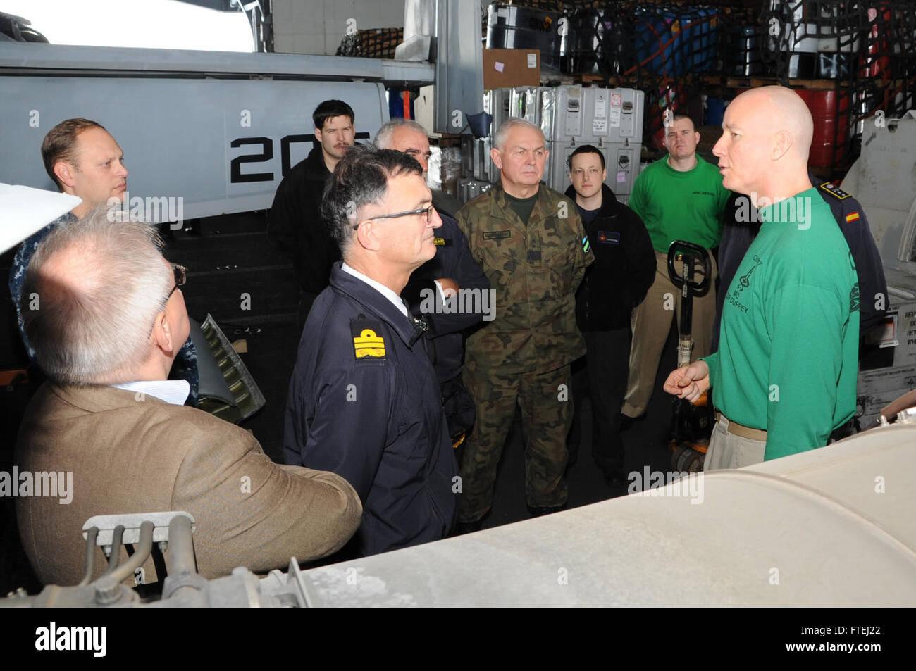 MEDITERRANEAN SEA (Oct. 30, 2014) Cmdr. Grady Duffey, maintenance officer of the aircraft carrier USS George H.W. Bush (CVN 77), gives a tour to distinguished visitors from Spain, Poland, Lithuania, Estonia and Latvia. George H.W. Bush, homeported in Norfolk, Va., is conducting naval operations in the U.S. 6th Fleet area of operations in support of U.S. national security interests in Europe. Stock Photo