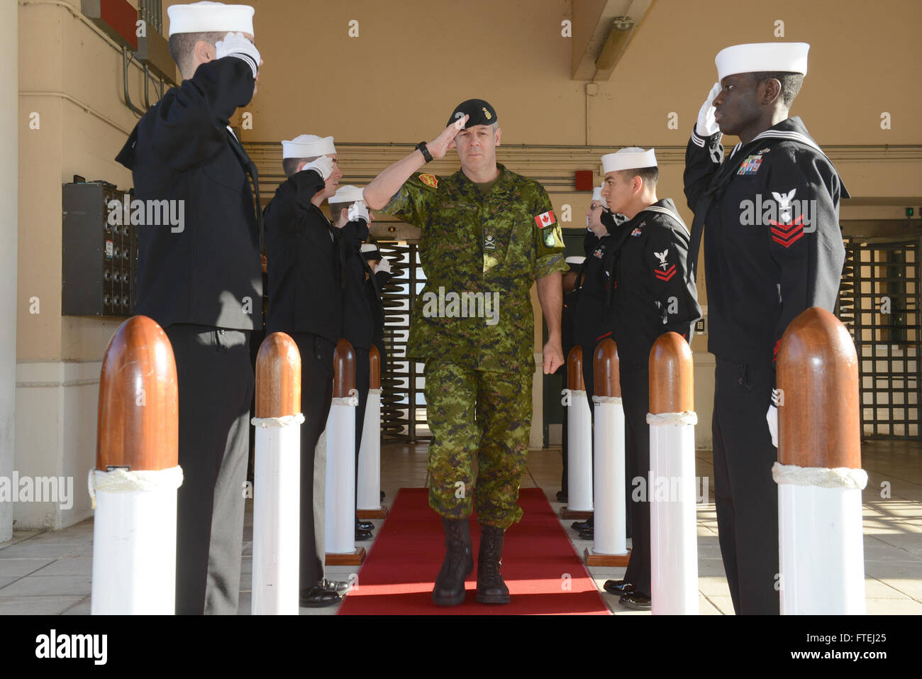 NAPLES, Italy (Oct. 30, 2014) Canadian Army Lt. Gen. Michael Day, Joint Force Command Naples deputy commander, passes through sideboys as he is welcomed to Commander, U.S. Naval Forces Europe-Africa/Commander, U.S. 6th Fleet (NAVEUR-NAVAF/C6F) headquarters. NAVEUR-NAVAF/C6F, headquartered in Naples, Italy, conducts the full spectrum of joint and naval operations, often in concert with allied, joint, and interagency partners, in order to advance U.S. national interests and security and stability in Europe and Africa. (Photo by Mass Communication Specialist 3rd Class Daniel Sc Stock Photo