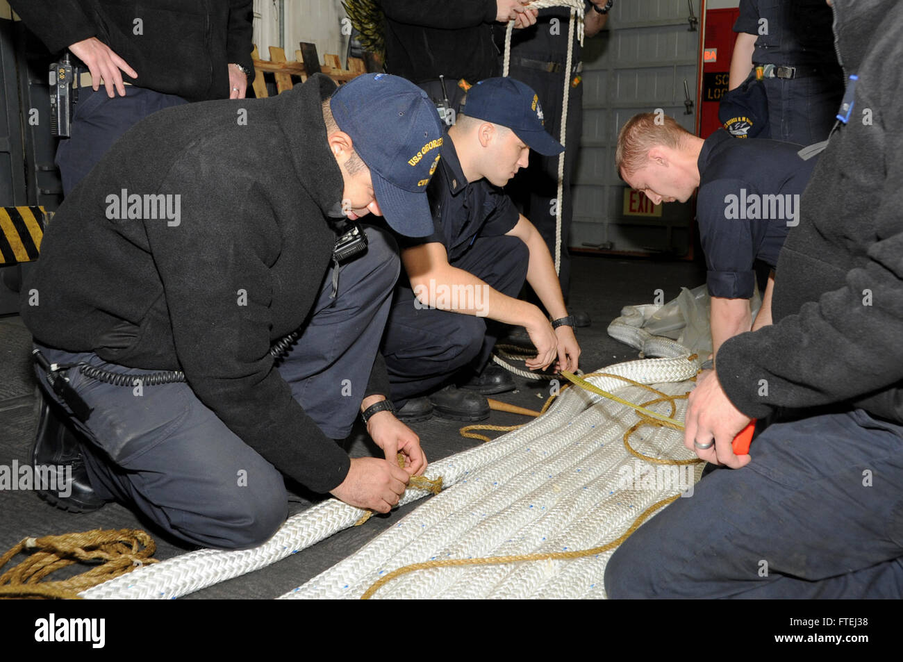 MEDITERRANEAN SEA (Nov. 1, 2014) Sailors splice a mooring line aboard the aircraft carrier USS George H.W. Bush (CVN 77). George H.W. Bush, homeported in Norfolk, Va., is conducting naval operations in the U.S. 6th Fleet area of operations in support of U.S. national security interests in Europe. Stock Photo