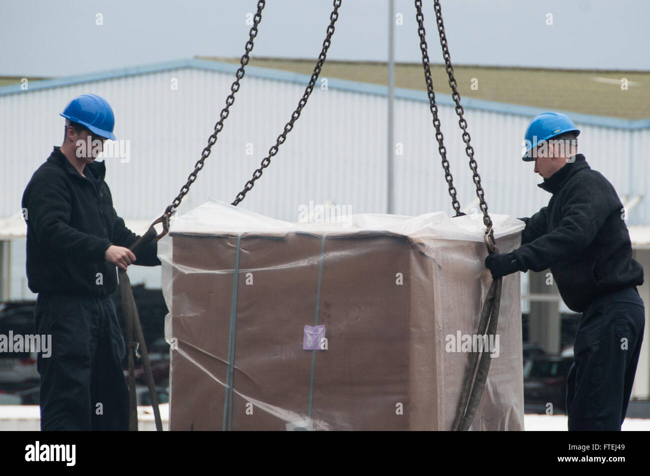 MARSEILLE, FRANCE (Nov. 4, 2014) Logistics Specialist Seaman Alec Olson, from Hastings, Minn., left, and Logistics Specialist 3rd Class Troy Wright, from Cocoa, Fla., load cargo aboard the aircraft carrier USS George H.W. Bush (CVN 77). George H.W. Bush, homeported in Norfolk, Va., is conducting naval operations in the U.S. 6th Fleet area of operations in support of U.S. national security interests in Europe. Stock Photo