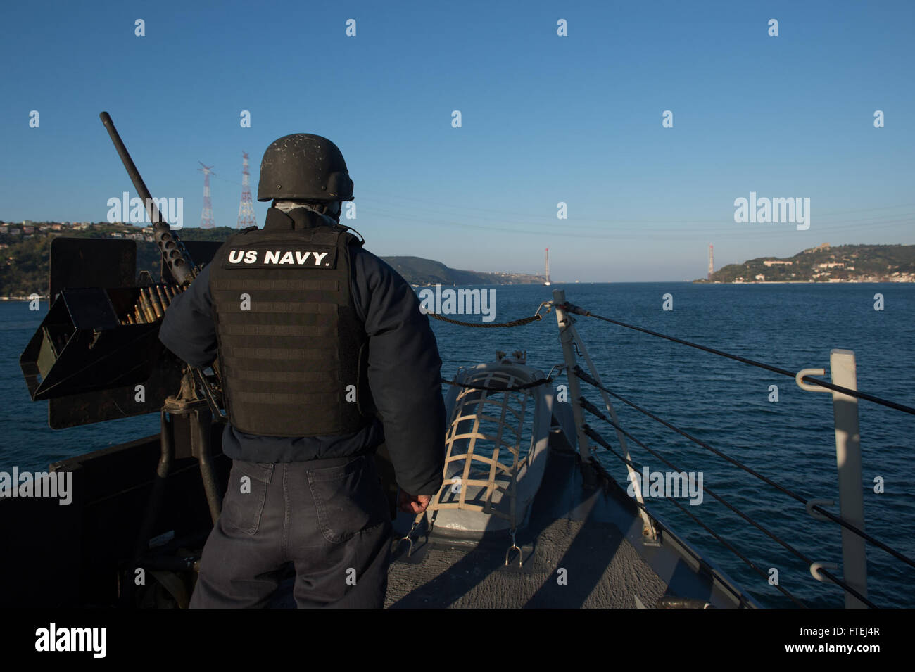 BOSPORUS STRAIGHTS  (Nov. 4, 2014) – Gunner’s Mate Seaman Nicholas Funderburk stands watch as part of the Small Caliber Attack Team (SCAT) on the forecastle of Arleigh Burke class guided-missile destroyer USS Ross (DDG 71) as she transits the Bosporus Straights in route to the Black Sea. Ross, homeported in Rota, Spain, is conducting naval operations in the U.S. 6th Fleet area of operations in support of U.S. national security interest in Europe. Stock Photo