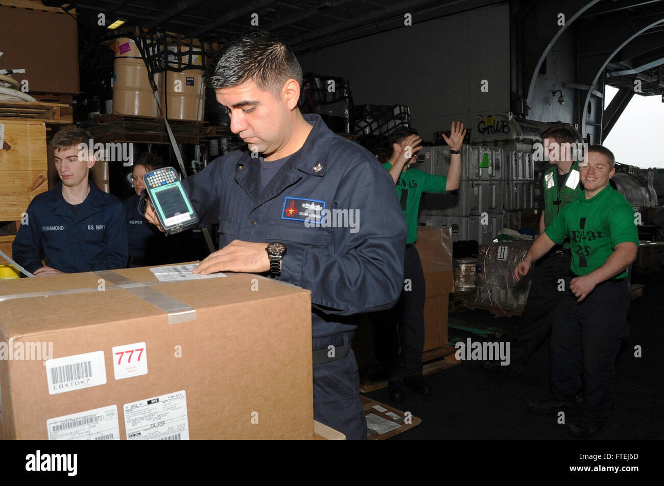 ATLANTIC OCEAN (Nov. 7, 2014) Logistics Specialist 3rd Class Oscar Alvarado, from McAllen, Texas, inventories supplies after a replenishment at sea aboard the aircraft carrier USS George H.W. Bush (CVN 77). George H.W. Bush, homeported in Norfolk, Va., is conducting naval operations in the U.S. 6th Fleet area of operations in support of U.S. national security interests in Europe. Stock Photo