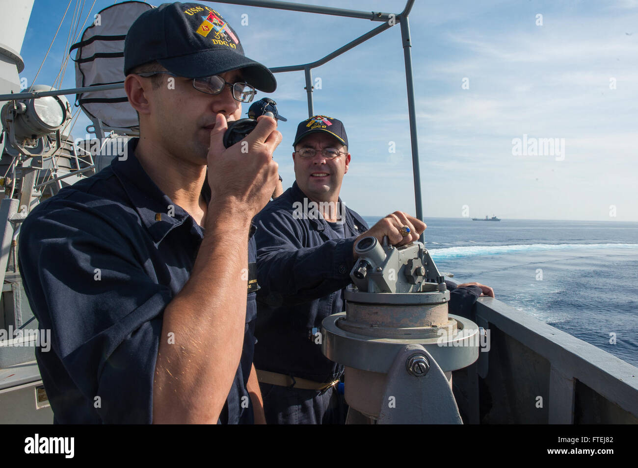 MEDITERRANEAN SEA (November 11, 2014) – Ensign James Russell, from Virginia Beach, orders a speed change aboard the Arliegh Burke-class guided-missile destroyer USS Cole (DDG 67) as the ship comes about during exercise Mavi Balina 2014. Exercise Mavi Balina is a biennial Turkish-led anti-submarine warfare maritime exercise involving NATO and regional forces in the eastern Mediterranean to improve interoperability and increase tactical proficiencies. Stock Photo