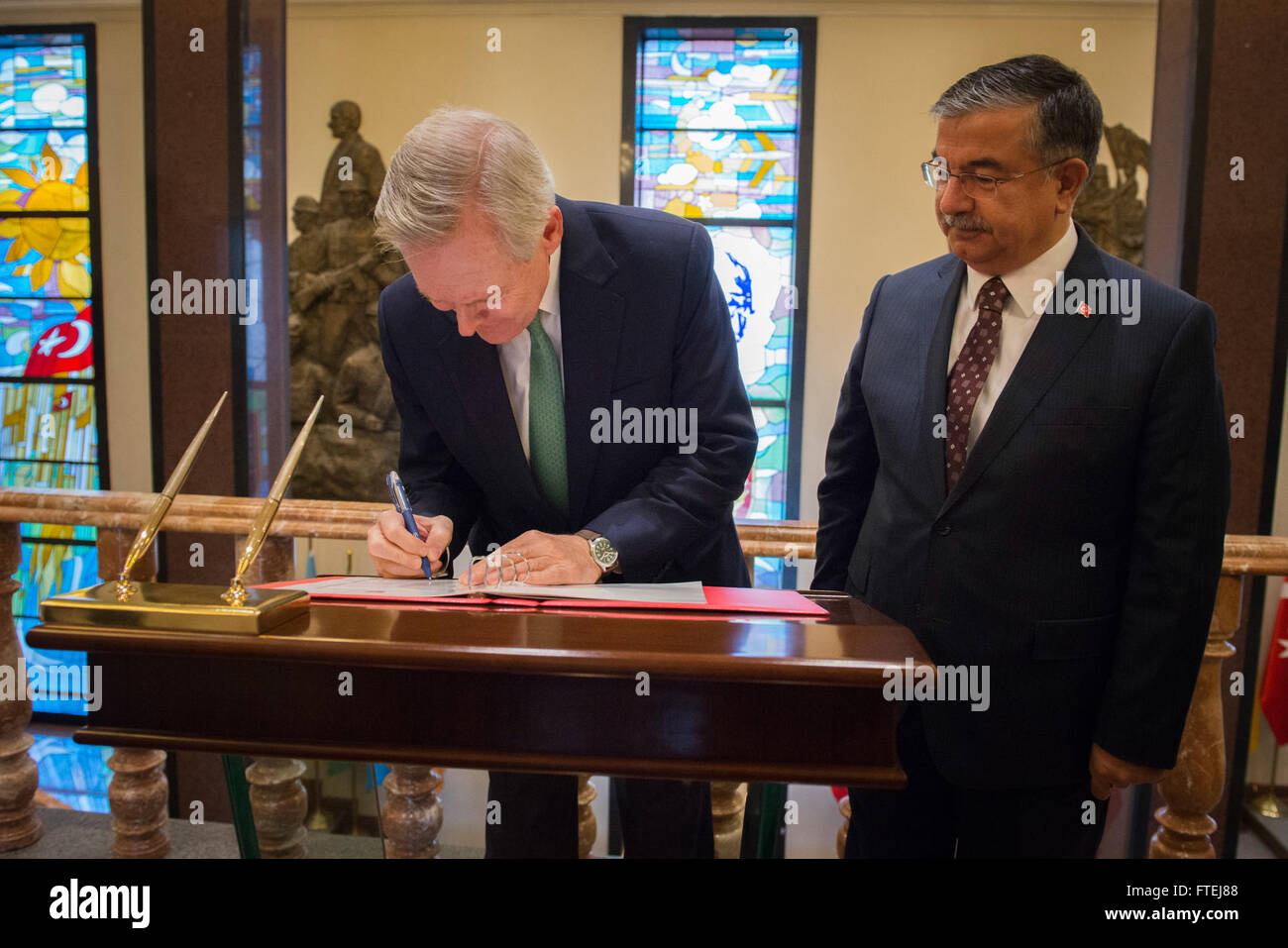 ANKARA, Turkey (Nov. 12, 2014) Secretary of the Navy (SECNAV) Ray Mabus signs the guest log at the Ministry of Defense as the Turkish Minister of Defense Ismet Yilmaz looks on. Mabus met with Yilmaz and other Turkish leaders to discuss Department of the Navy relations between the two countries. Stock Photo