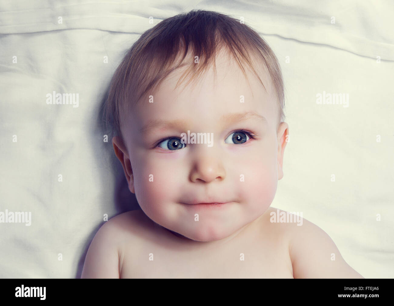 cute one year old baby boy in bed, top view Stock Photo Alamy