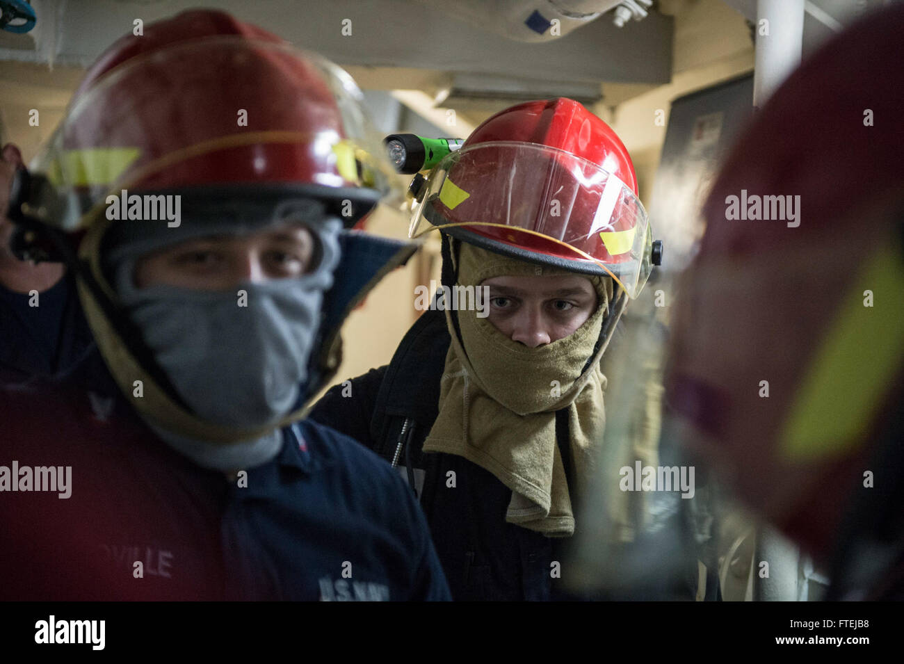 MEDITERRANEAN SEA (Nov. 20, 2014) – Damage Controlman 2nd Jeremy Key, from Lexington, Kentucky, directs Sailors to combat a flooding casualty aboard the USS Cole (DDG 67) during a general quarters drill, Nov. 20. Cole, an Arleigh Burke-class guided-missile destroyer, homeported in Norfolk, is conducting naval operations in the U.S. 6th Fleet area of operations in support of U.S. national security interests in Europe. Stock Photo