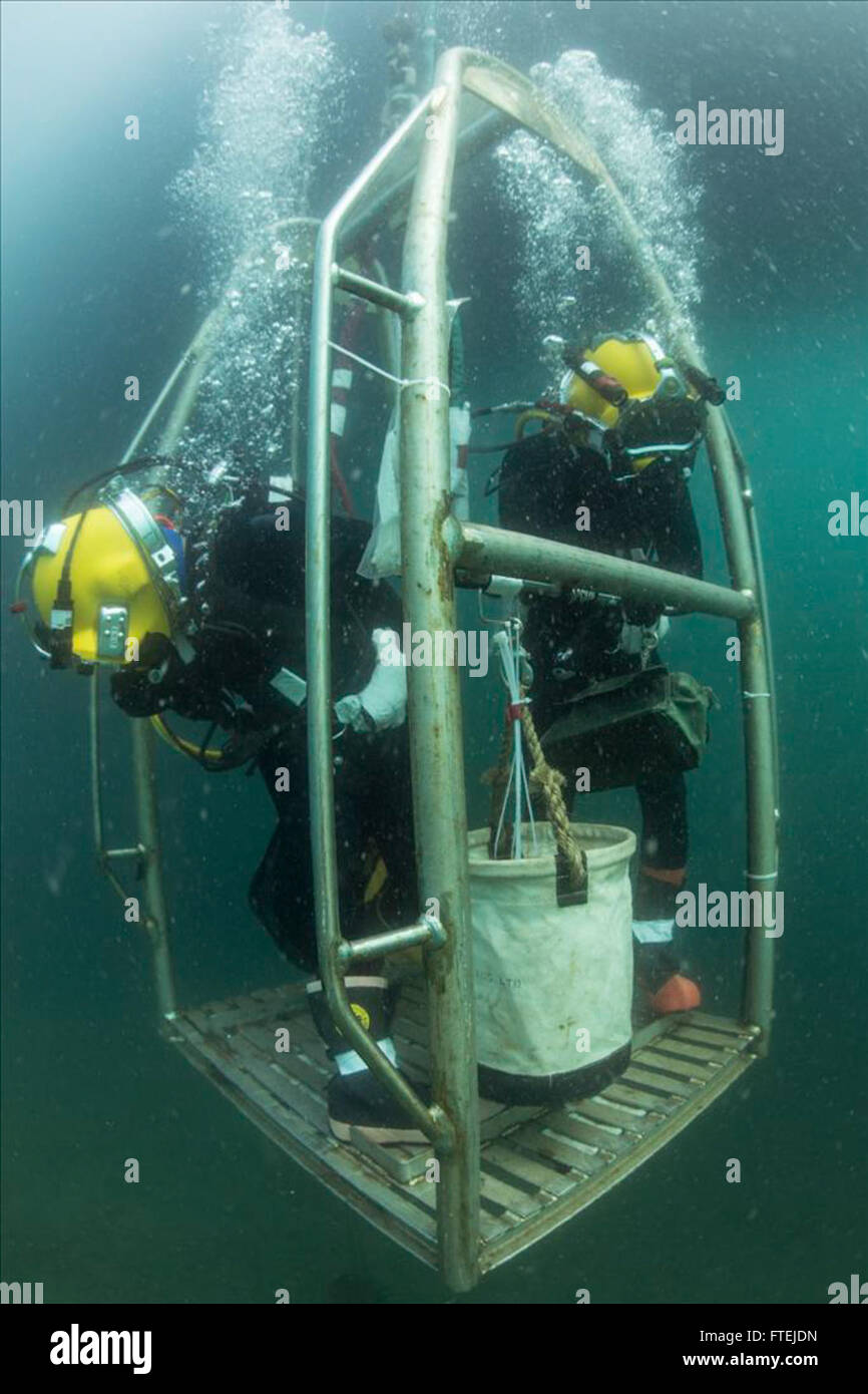 TRIESTE, Italy (Aug. 31, 2015) Navy Diver 2nd Class Octavio Alvarez, left, watches for the sea floor as he and Navy Diver 3rd Class James Lindley descend to conduct excavation of a U.S. aircraft crash site in support of an ongoing Defense Personnel Accounting Agency (DPAA) mission in the northern Adriatic Sea Aug. 31, 2015. Divers from Mobile Diving Salvage Unit 2 and Civilian Mariners from the Military Sealift Command rescue and salvage ship USNS Grasp (T-ARS 51), assigned to Commander, Task Force 68, are currently supporting DPAA for the recovery of U.S. Airmen who have be Stock Photo