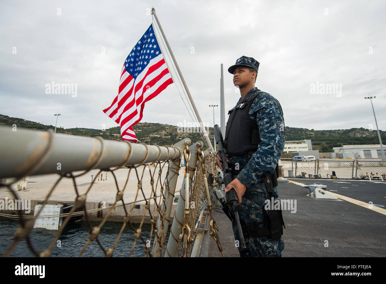 SOUDA BAY, Greece (November 27, 2014) – Boatswain’s Mate 3rd Class Dontrell Dorsett, from Fort Worth, Texas, stands topside security rover aboard the USS Cole (DDG 67). Cole an Arleigh Burke-class guided-missile destroyer homeported in Norfolk, is conducting naval operations in the U.S. 6th Fleet area of operations in support of U.S. national security interests in Europe. Stock Photo