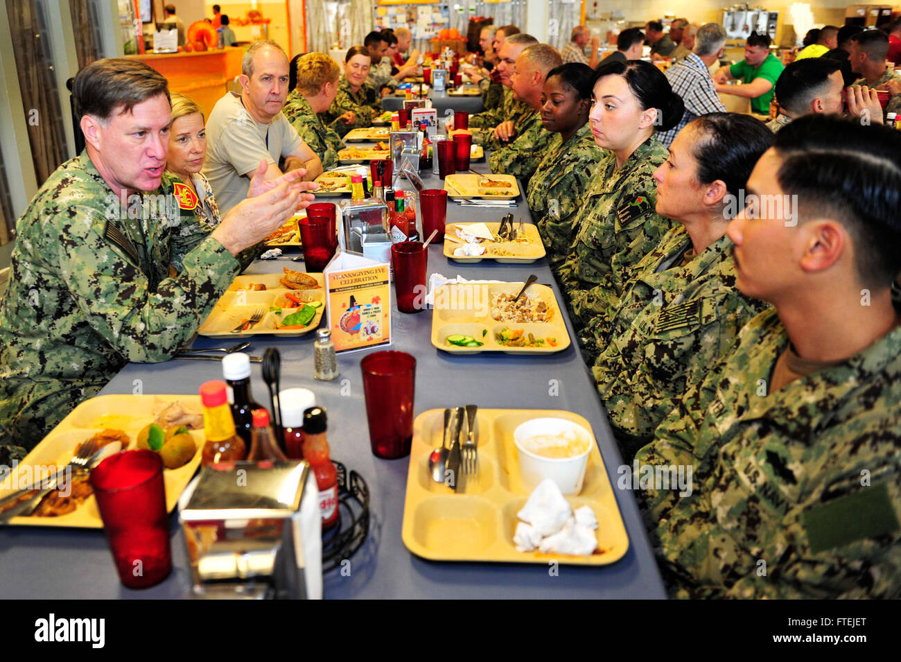 CAMP LEMONNIER, Djibouti (Nov. 27, 2014) Adm. Mark Ferguson, commander, U.S. Naval Forces Europe-Africa (left) and U.S. Ambassador to Djibouti, Tom Kelly, speaks to service members during Thanksgiving Day lunch at Camp Lemonnier. Ferguson visited Camp Lemonnier to thank Sailors for supporting forward U.S. forces and for strengthening security in East Africa. Stock Photo
