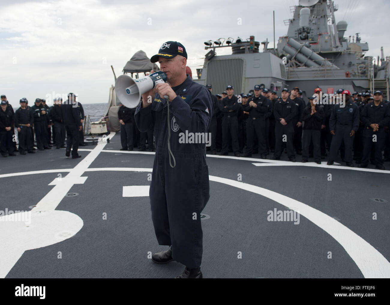 MEDITERRANEAN SEA (Dec. 01, 2014) Cmdr. Charles Hampton, USS Donald Cook (DDG 75) commanding officer, congratulates newly-promoted petty officers following a  frocking ceremony aboard the ship’s flight deck Dec. 1, 2014. Donald Cook, an Arleigh Burke-class guided-missile destroyer, forward-deployed to Rota, Spain, is conducting naval operations in the U.S. 6th Fleet area of operations in support of U.S. national security interests in Europe. Stock Photo