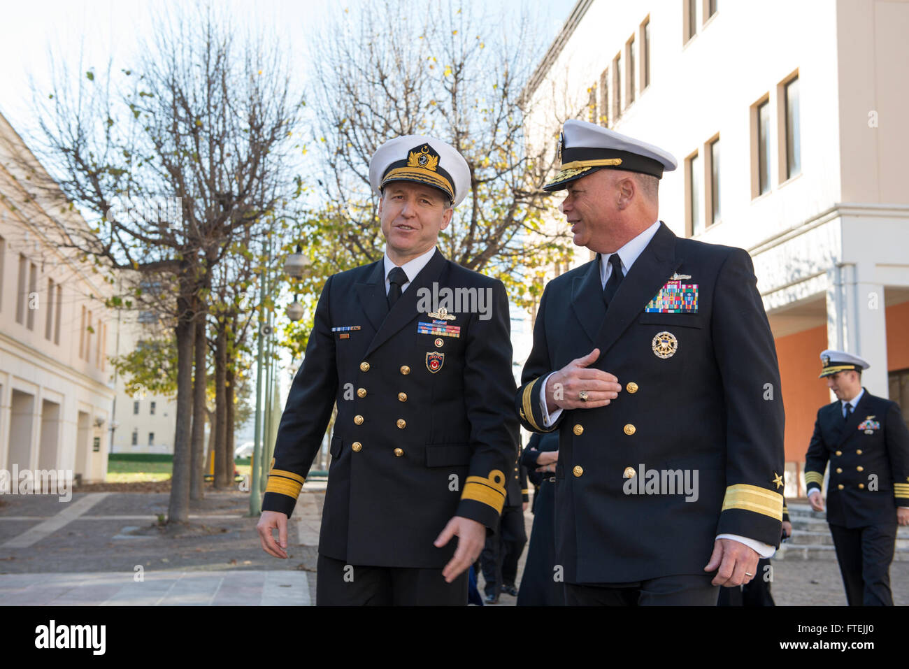 (Dec. 10, 2014) Turkish navy Rear Adm. Oguz Karaman, head of Turkish Naval Forces Commandâs Plans and Policy Division, left, walks with Rear Adm. John Nowell, chief of staff, U.S. Naval Forces Europe-Africa, at Naval Support Activity Naples, Dec. 10, 2014. U.S. Naval Forces Europe-Africa/U.S. 6th Fleet staff hosted a Turkish naval delegation to discuss future opportunities to strengthen interoperability. Stock Photo