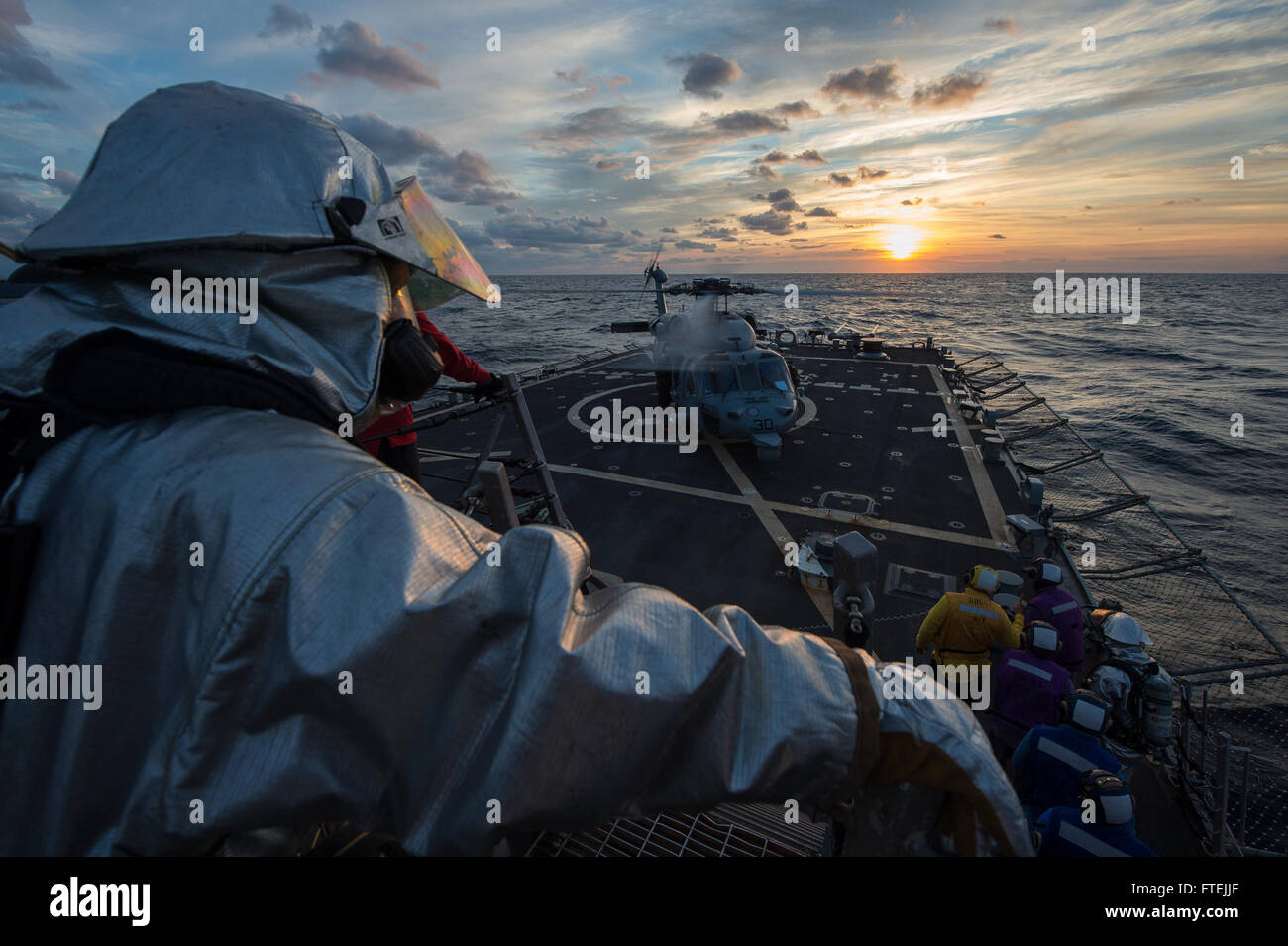 MEDITERRANEAN SEA (Dec. 11, 2014) An MH 60S Sea Hawk helicopter attached to the Dragon Whales of Helicopter Sea Combat Squadron (HSC) 28 lands aboard USS Cole (DDG 67) for refueling during deck-landing qualifications, Dec. 11 2014. Cole, an Arleigh Burke-class guided-missile destroyer, homeported in Norfolk, is conducting naval operations in the U.S. 6th Fleet area of operations in support of U.S. national security interests in Europe. Stock Photo