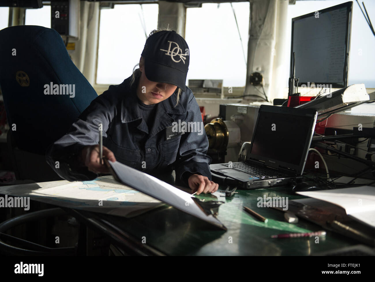 MEDITERRANEAN SEA (Dec. 13, 2014) Quartermaster 3rd Class Sarah Watson, from Douglasville, Georgia, plots a course on a chart in the bridge aboard USS Donald Cook (DDG 75). Donald Cook, an Arleigh Burke-class guided-missile destroyer, forward-deployed to Rota, Spain, is conducting naval operations in the U.S. 6th Fleet area of operations in support of U.S. national security interests in Europe. Stock Photo