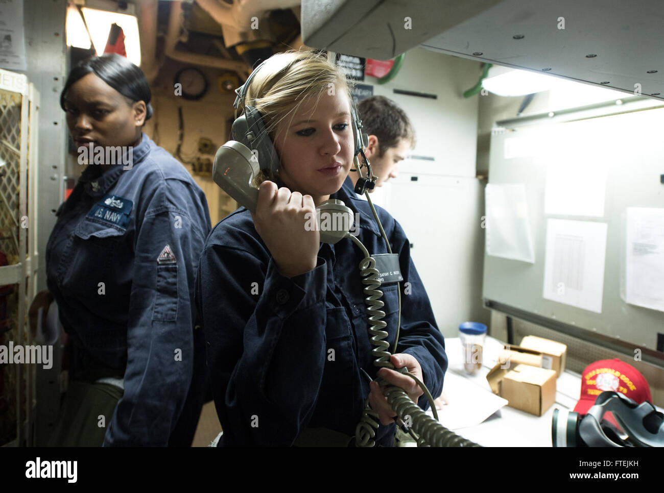 MEDITERRANEAN SEA (Dec. 16, 2014) Quartermaster 3rd Class Sarah Watson, from Douglasville, Georgia, stands watch as a phone talker during a general quarters drill aboard USS Donald Cook (DDG 75) Dec. 16, 2014. Donald Cook, an Arleigh Burke-class guided-missile destroyer, forward-deployed to Rota, Spain, is conducting naval operations in the U.S. 6th Fleet area of operations in support of U.S. national security interests in Europe. Stock Photo