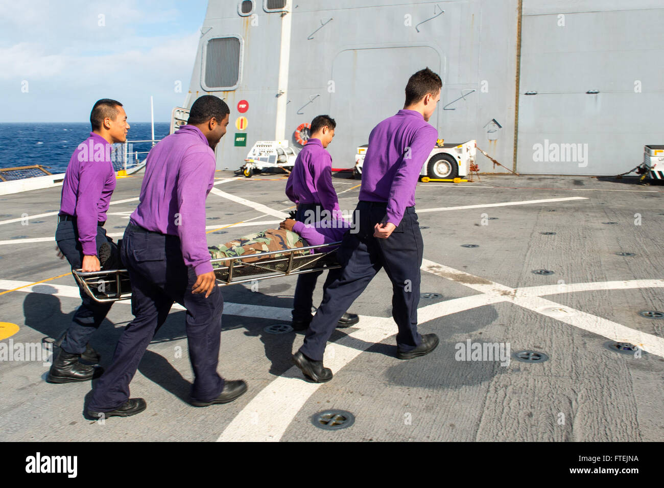 ATLANTIC OCEAN (Dec. 21, 2014) Sailors practice stretcher-bearer procedures during flight deck damage control training aboard USS New York (LPD 21) Dec. 21, 2014. New York, a San Antonio-class amphibious transport dock ship that is part of the Iwo Jima Amphibious Ready Group/24th Marine Expeditionary Unit, is conducting naval operations in the U.S. 6th Fleet area of operations in support of U.S. national security interests in Europe. Stock Photo