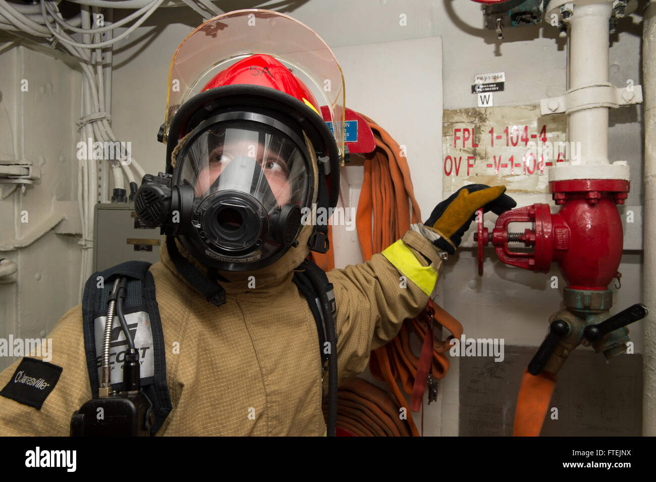 ATLANTIC OCEAN (Dec. 23, 2014) Hull Maintenance Technician Fireman Joseph Porter, from Allentown, Pennsylvania, mans a fire plug during a fire-fighting drill aboard the Wasp-class amphibious assault ship USS Iwo Jima (LHD 7) Dec. 23, 2014. The Iwo Jima Amphibious Ready Group/24th Marine Expeditionary Unit is conducting naval operations in the U.S. 6th Fleet area of operations in support of U.S. national security interests in Europe. Stock Photo