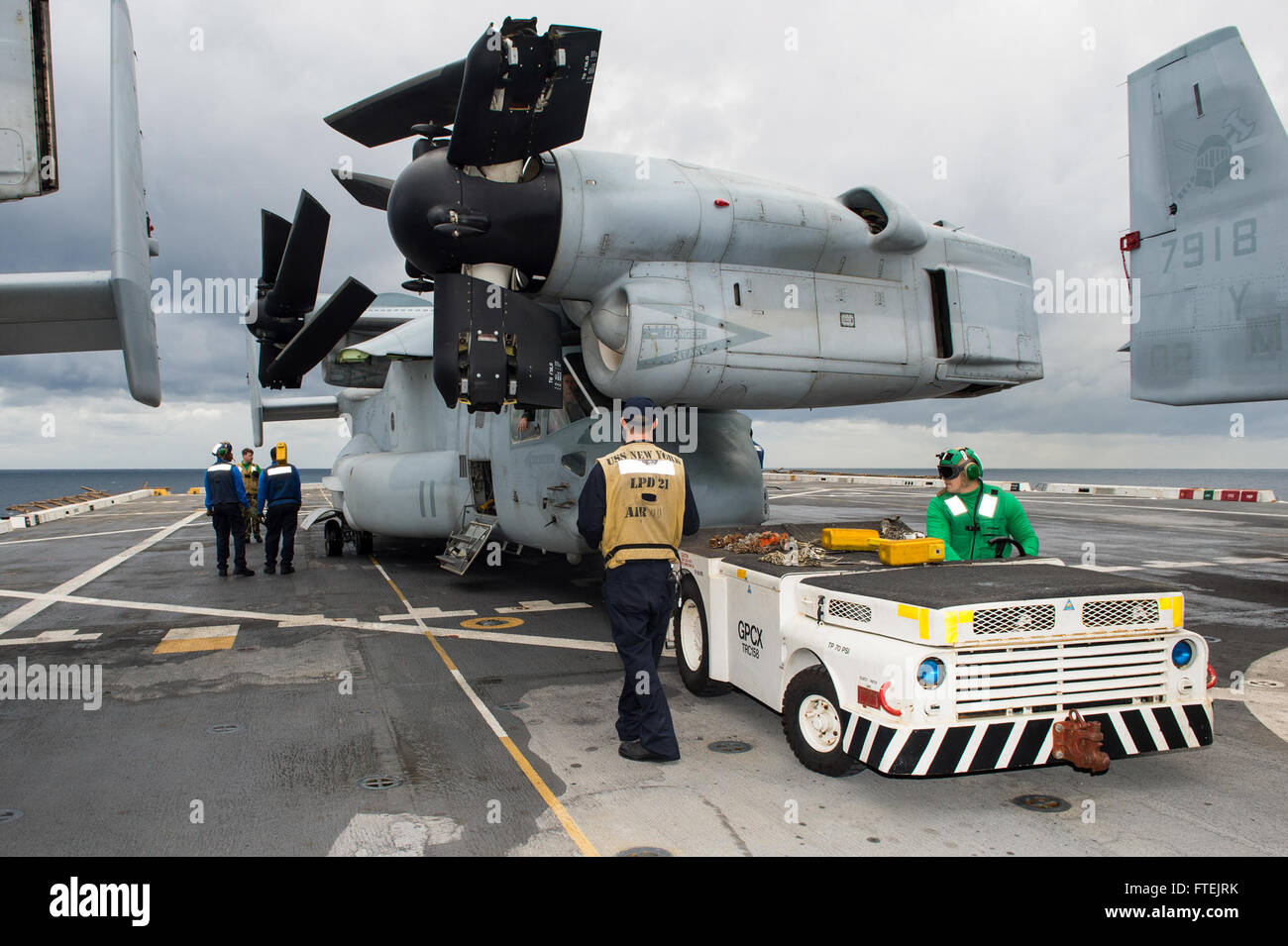 MEDITERRANEAN SEA (Dec. 27, 2014) Sailors aboard the San Antonio-class amphibious transport dock ship USS New York (LPD 21) reposition an MV-22B Osprey on the flight deck in preparation for flight operations Dec. 26, 2014. New York, part of the Iwo Jima Amphibious Ready Group/24th Marine Expeditionary Unit, is conducting naval operations in the U.S. 6th Fleet area of operations in support of U.S. national security interests in Europe Stock Photo