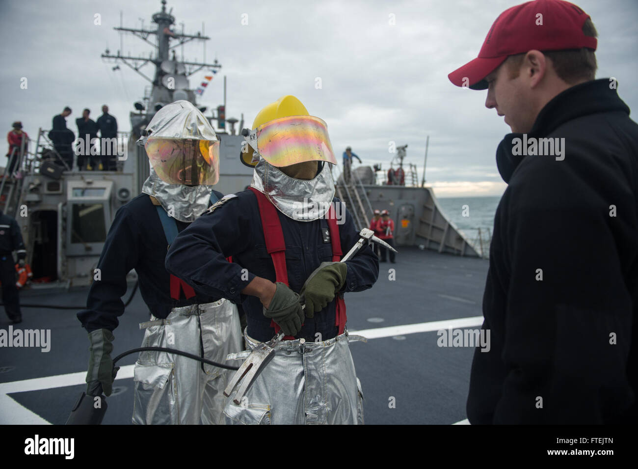 BLACK SEA (Dec. 29, 2014) Sailors assigned to USS Donald Cook (DDG 75) respond to a simulated aircraft crash during a crash-and-salvage drill on the flight deck Dec. 29, 2014. Donald Cook, an Arleigh Burke-class guided-missile destroyer, forward-deployed to Rota, Spain, is conducting naval operations in the U.S. 6th Fleet area of operations in support of U.S. national security interests in Europe. Stock Photo