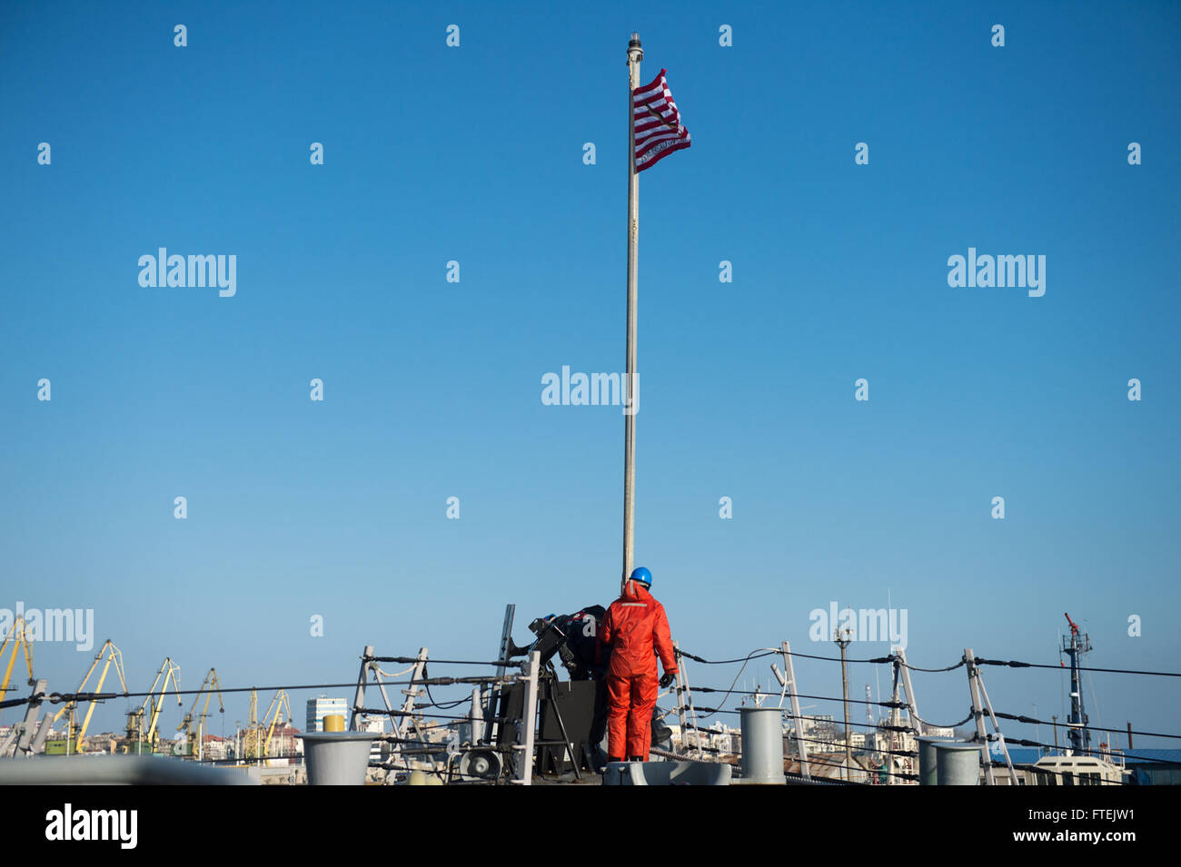 CONSTANTA, Romania (Dec. 30, 2014) Sailors raise the Union Jack flag as USS Donald Cook (DDG 75) arrives at Constanta, Romania for a scheduled port visit Dec. 30, 2014. Donald Cook, an Arleigh Burke-class guided-missile destroyer, forward-deployed to Rota, Spain, is conducting naval operations in the U.S. 6th Fleet area of operations in support of U.S. national security interests in Europe. Stock Photo