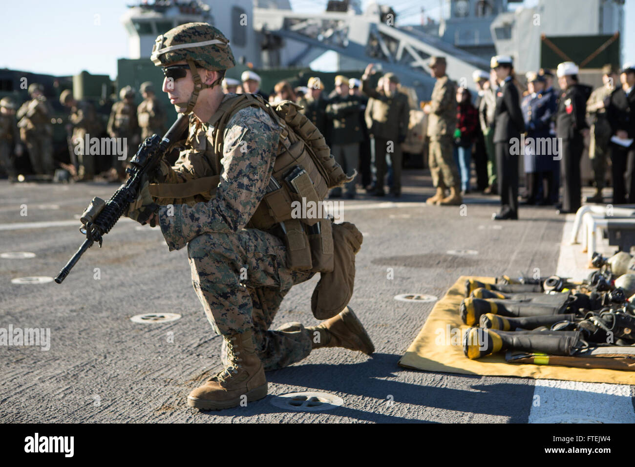 VALENCIA, Spain (Dec. 31, 2014) Cpl. Fabaino E. Tornberg, a machine gunner with Battalion Landing Team 3rd Battalion, 6th Marine Regiment, 24th Marine Expeditionary Unit, conducts a tactical halt during a tactics demonstration for Spanish government and military officials aboard USS Fort McHenry (LSD 43) in Valencia, Spain, Dec. 31, 2014. The 24th MEU and Iwo Jima Amphibious Ready Group are conducting naval operations in the U.S. 6th Fleet area of operations in support of U.S. national security interests in Europe. Stock Photo