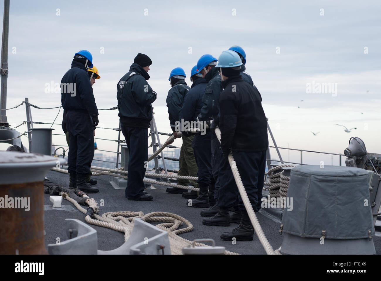 CONSTANTA, Romania (Jan. 3, 2015) Sailors assigned to USS Donald Cook (DDG 75), participate in a line-handling detail as the ship prepares to get underway after a scheduled port visit in Constanta, Romania, Jan. 3, 2015. Donald Cook, an Arleigh Burke-class guided-missile destroyer, forward-deployed to Rota, Spain, is conducting naval operations in the U.S. 6th Fleet area of operations in support of U.S. national security interests in Europe. Stock Photo