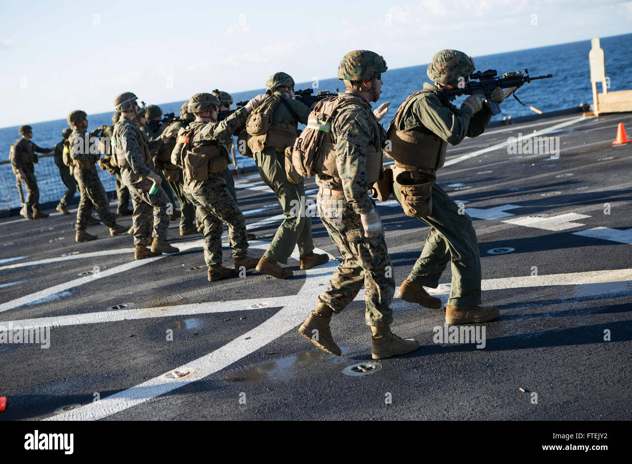 150105-M-AR522-143 MEDITERRANEAN SEA (Jan. 5, 2015) Marines assigned to Kilo Company, Battalion Landing Team 3rd Battalion, 6th Marine Regiment, 24th Marine Expeditionary Unit, fire their service rifles in the movement-to-contact phase of a live-fire qualification aboard USS Fort McHenry (LSD 43) Jan. 5, 2015. The 24th MEU and Iwo Jima Amphibious Ready Group are conducting naval operations in the U.S. 6th Fleet area of operations in support of U.S. national security interests in Europe. (U.S. Marine Corps photo by Sgt. Devin Nichols/Released) Stock Photo