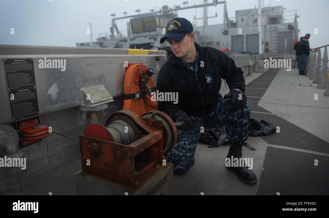 150106-N-RB579-056 ROTA, Spain (Jan. 6, 2015) Operations Specialist 2nd Class Joshua Watts unwinds the brow wench aboard USNS Spearhead as the ship moors for a scheduled port visit in Rota, Spain, Jan. 6, 2015. Spearhead is on a scheduled deployment to the U.S. 6th Fleet area of operations to support the international collaborative capacity-building program Africa Partnership Station. (U.S. Navy photo by Mass Communication Specialist 1st Class Joshua Davies/Released) Stock Photo