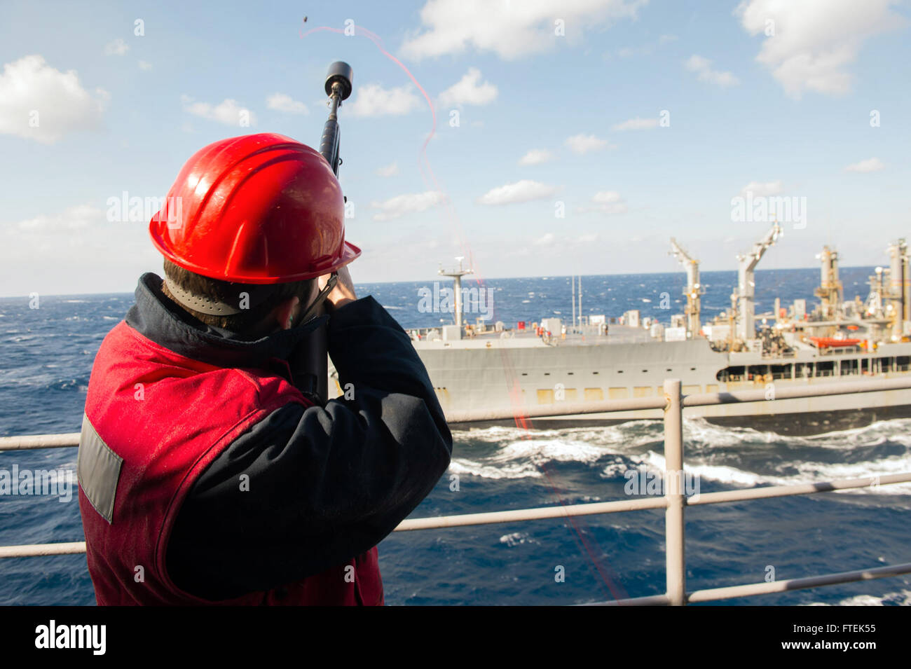 150108-N-KD168-059 MEDITERRANEAN SEA (Jan. 8, 2015) Gunner's Mate Seaman Shane Conroy, a Cheyenne, Wyoming native, fires a shot line from USS Iwo Jima (LHD 7) over to Military Sealift Command fleet replenishment oiler USNS Kanawha (T-AO-196) during a replenishment-at-sea, Jan. 8, 2015. Iwo Jima, a Wasp-class amphibious assault ship, deployed as part of the Iwo Jima Amphibious Readiness Group/24th Marine Expeditionary Unit, is conducting naval operations in the U.S. 6th Fleet area of operations in support of U.S. national security interests in Europe. (U.S. Navy photo by Mass Communication Spec Stock Photo