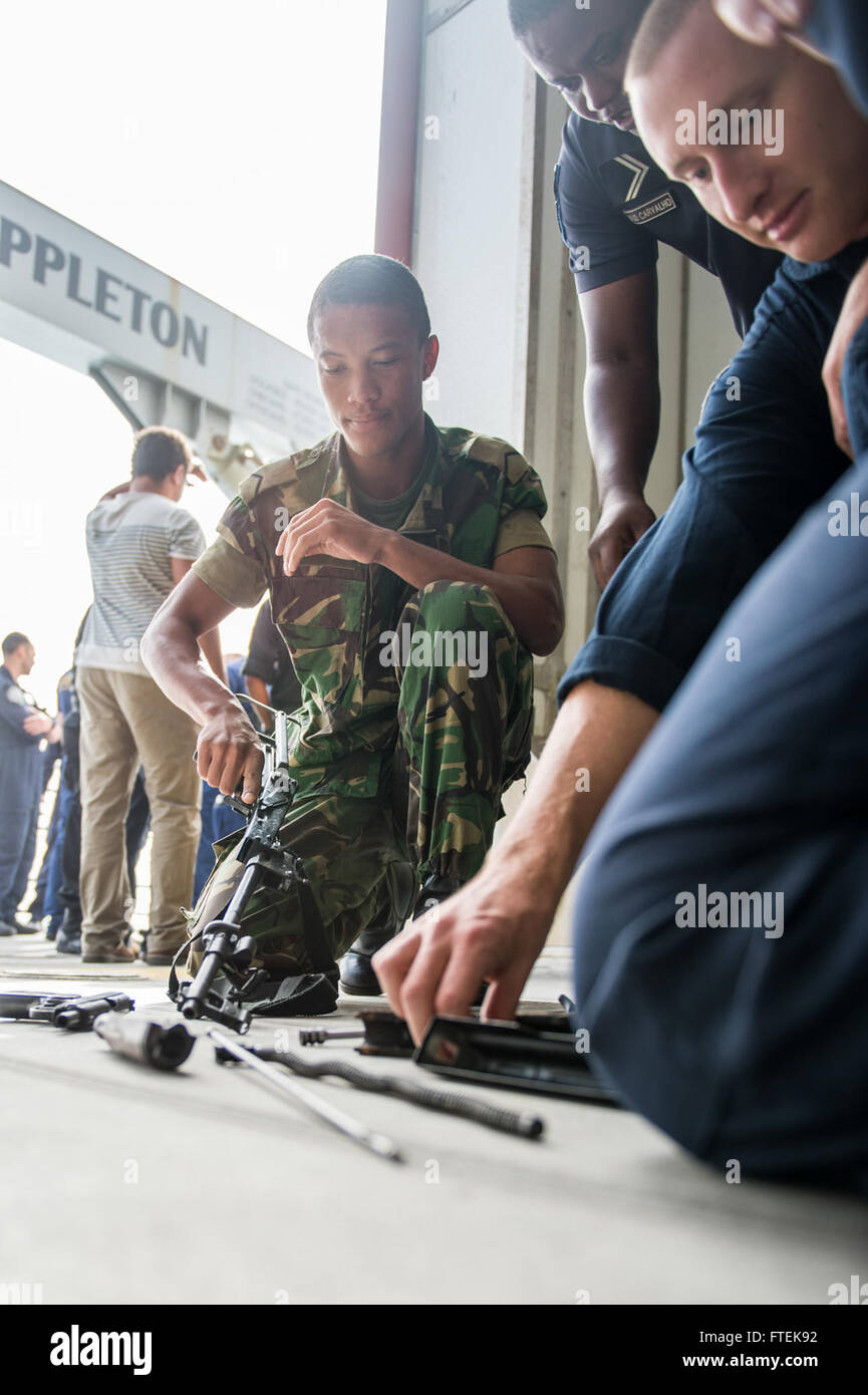 150114-N-JP249-065 ATLANTIC OCEAN (Jan. 14, 2015) Members of the Cabo Verde Coast Guard and the U.S. Coast Guard’s Law Enforcement Detachment 407 practice disassembling an AK-47 machine gun aboard the Military Sealift Command’s joint high-speed vessel USNS Spearhead (JHSV 1) Jan. 14, 2015. Spearhead is on a scheduled deployment to the U.S. 6th Fleet area of operations in support of the international collaborative capacity-building program Africa Partnership Station. (U.S. Navy photo by Mass Communication Specialist 2nd Class Kenan O’Connor/Released) Stock Photo