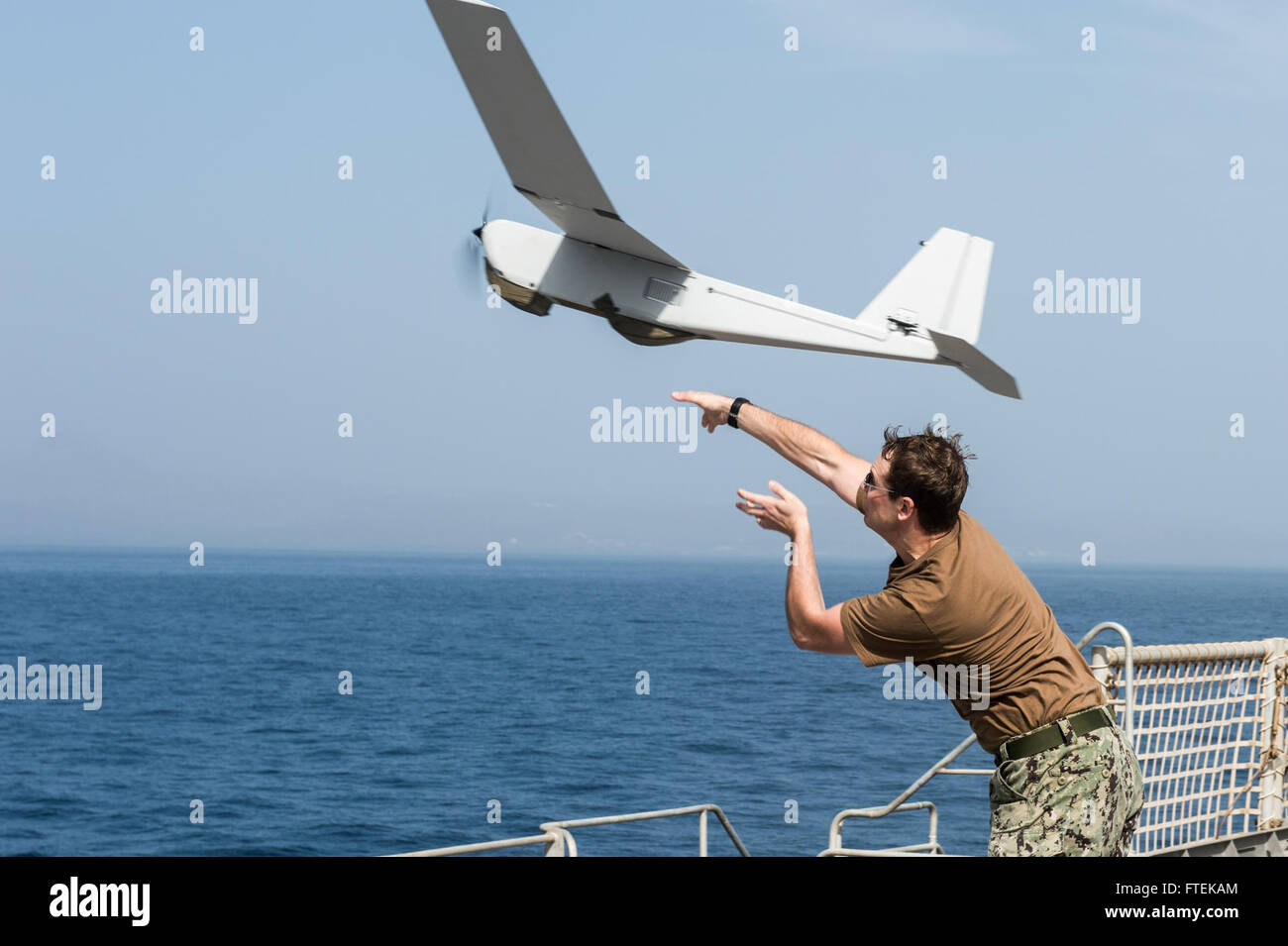 150116-N-JP249-058 ATLANTIC OCEAN (Jan. 16, 2015) Intelligence Specialist 2nd Class Joshua Lesperance, from Spring Valley, Illinois,  launches a Puma Unmanned Aircraft System from the Coastal Riverine Force, while aboard the Military Sealift Command’s joint high-speed vessel USNS Spearhead (JHSV 1) Jan. 16, 2015. Spearhead is on a scheduled deployment to the U.S. 6th Fleet area of operations in support of the international collaborative capacity-building program Africa Partnership Station. (U.S. Navy photo by Mass Communication Specialist 2nd Class Kenan O’Connor/Released) Stock Photo
