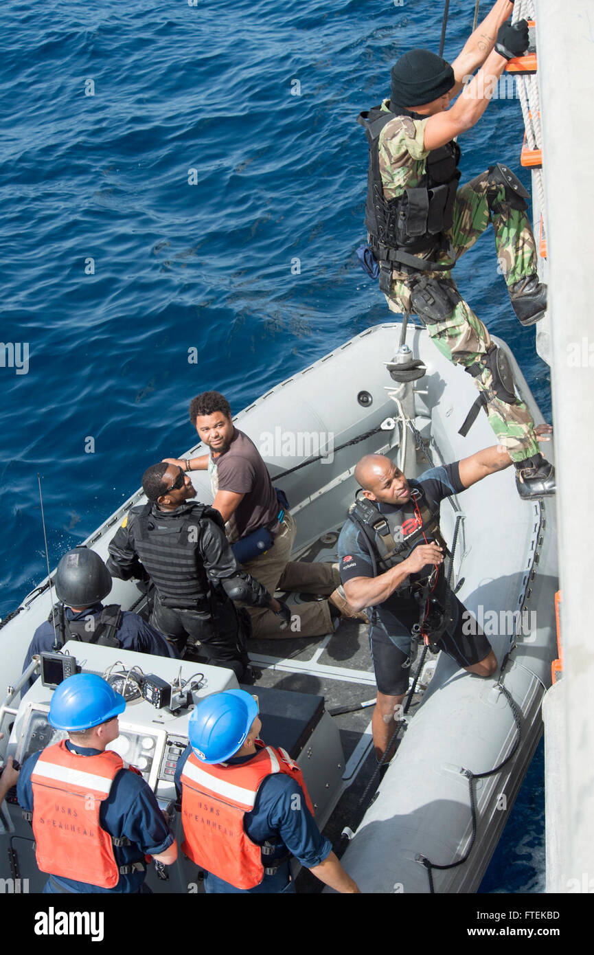 A member of the Cabo Verde coast guard climbs aboard the USNS Spearhead ...