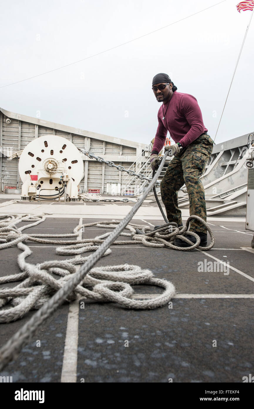 DAKAR, Senegal (Jan. 24, 2015) Able Bodied Seaman Joe Lyons, a civil service mariner, hauls in lines in preparation of getting the Military Sealift Command’s joint high-speed vessel USNS Spearhead (JHSV 1) underway Jan. 24, 2015. Spearhead is on a scheduled deployment to the U.S. 6th Fleet area of operations to support the international collaborative capacity-building program Africa Partnership Station. Stock Photo