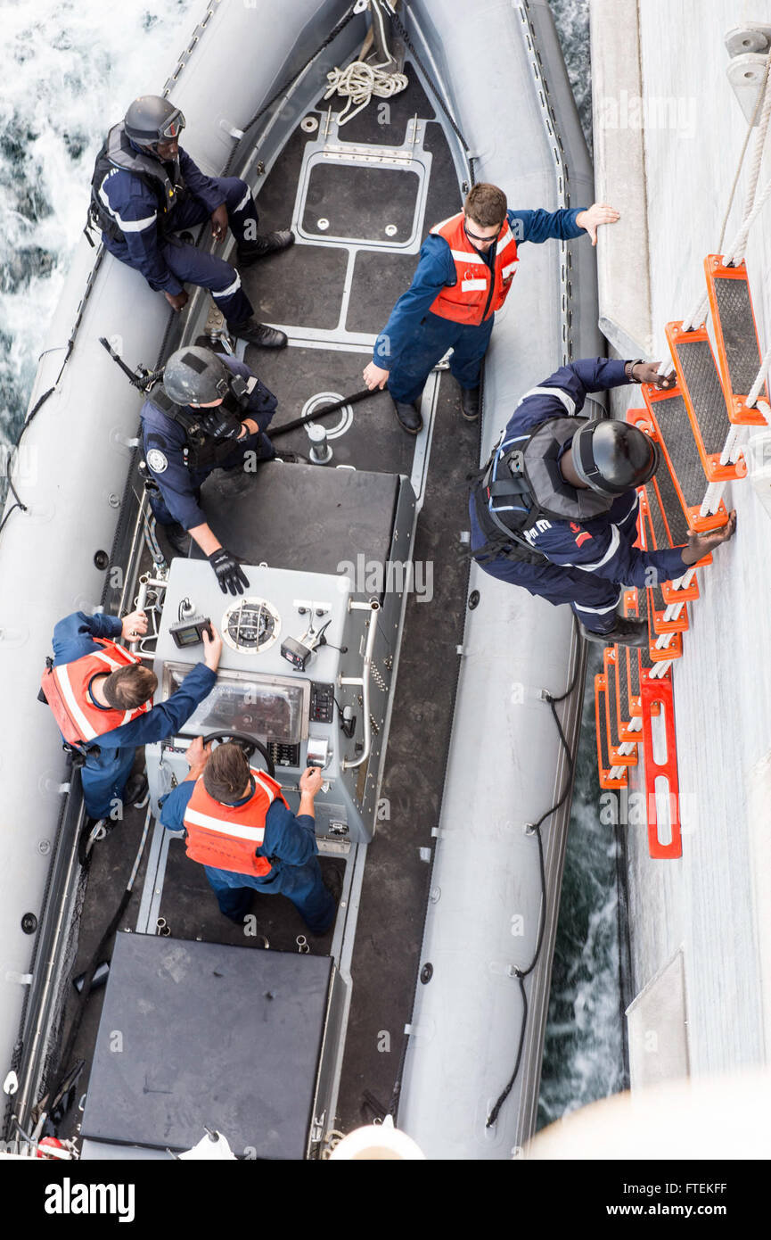 ATLANTIC OCEAN (Jan. 24, 2015) A boarding team member from the Senegal military climbs down from USNS Spearhead (JHSV 1) to a waiting rigid hull inflatable boat Jan. 24, 2015. Spearhead is on a scheduled deployment to the U.S. 6th Fleet area of operations to support the international collaborative capacity-building program Africa Partnership Station. Stock Photo