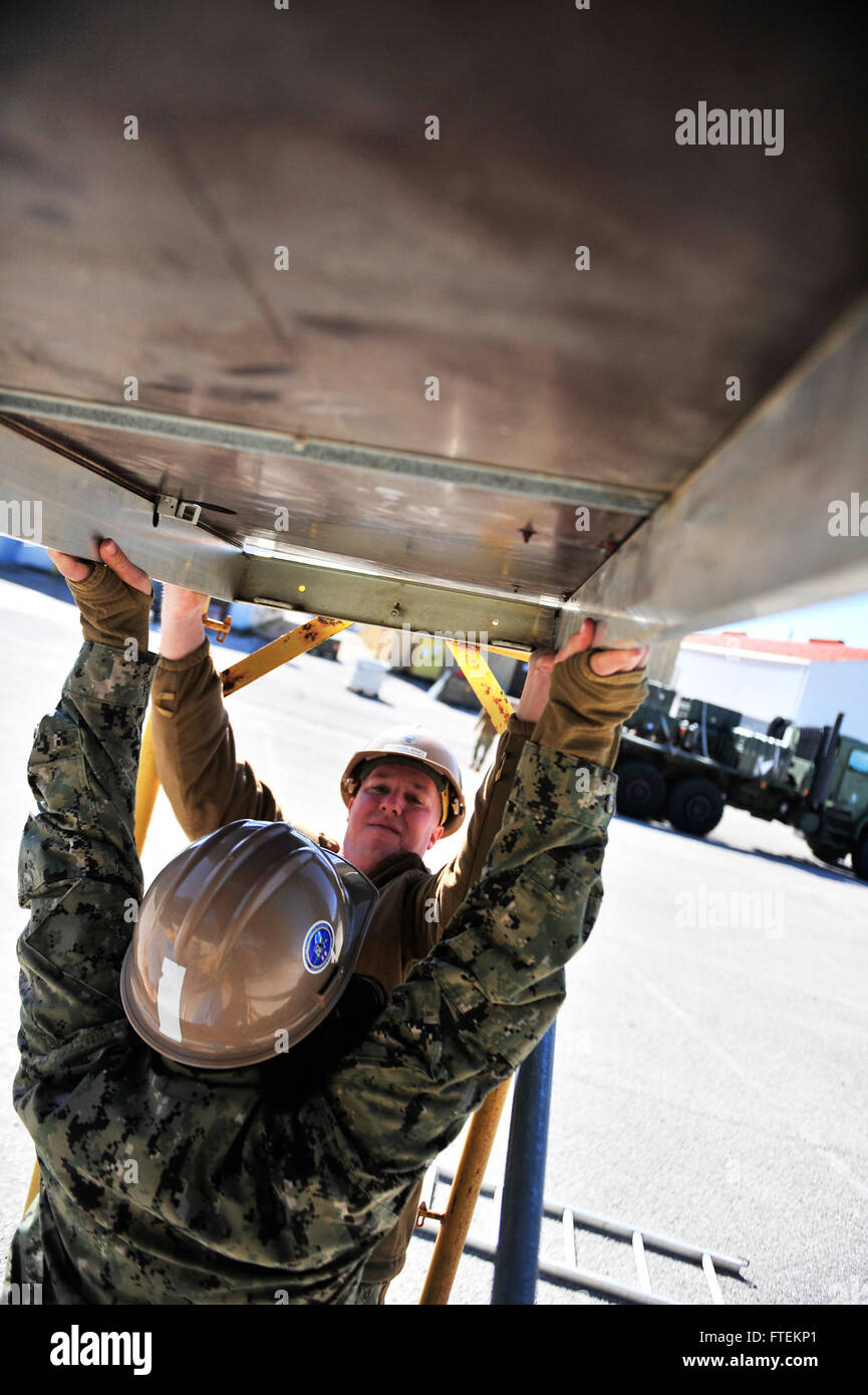 NAVAL STATION ROTA, Spain (Feb. 4, 2015) Steelworker 3rd Class Shawn Hoagland and Steelworker Constructionman Amber Jenkins, assigned to Naval Mobile Construction Battalion (NMCB) 11, add a layer to scaffolding during the set up phase for an upcoming project Feb. 4, 2015. NMCB 11 is currently deployed to 14 different detachment sites throughout European Command, African command, Pacific Command and Central Command; promoting security and stability by conducting general engineering, disaster relief, construction readiness operations and Human civic action support. (U.S. Navy Stock Photo