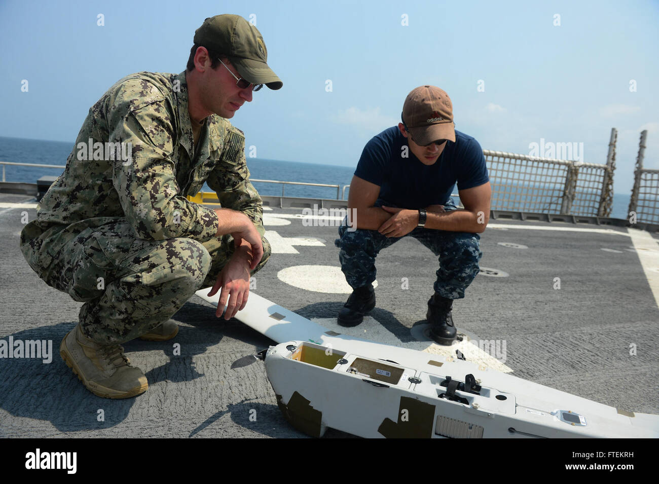 ATLANTIC OCEAN (Feb. 7, 2015) Information Technology Specialist 2nd Class Joshua Lesperance from Spring Valley, Ill. (left) and Intelligence Specialist 3rd Class Erik Grace of Houston, Texas (right) conduct routine maintenance on the Aqua Puma unmanned aerial system aboard the Military Sealift Command's joint high-speed vessel USNS Spearhead (JHSV 1), Feb. 7, 2015. Spearhead is on a scheduled deployment to the U.S. 6th Fleet area of operations in support of the international collaborative capacity-building program Africa Partnership Station. (U.S. Navy photo by Mass Communic Stock Photo
