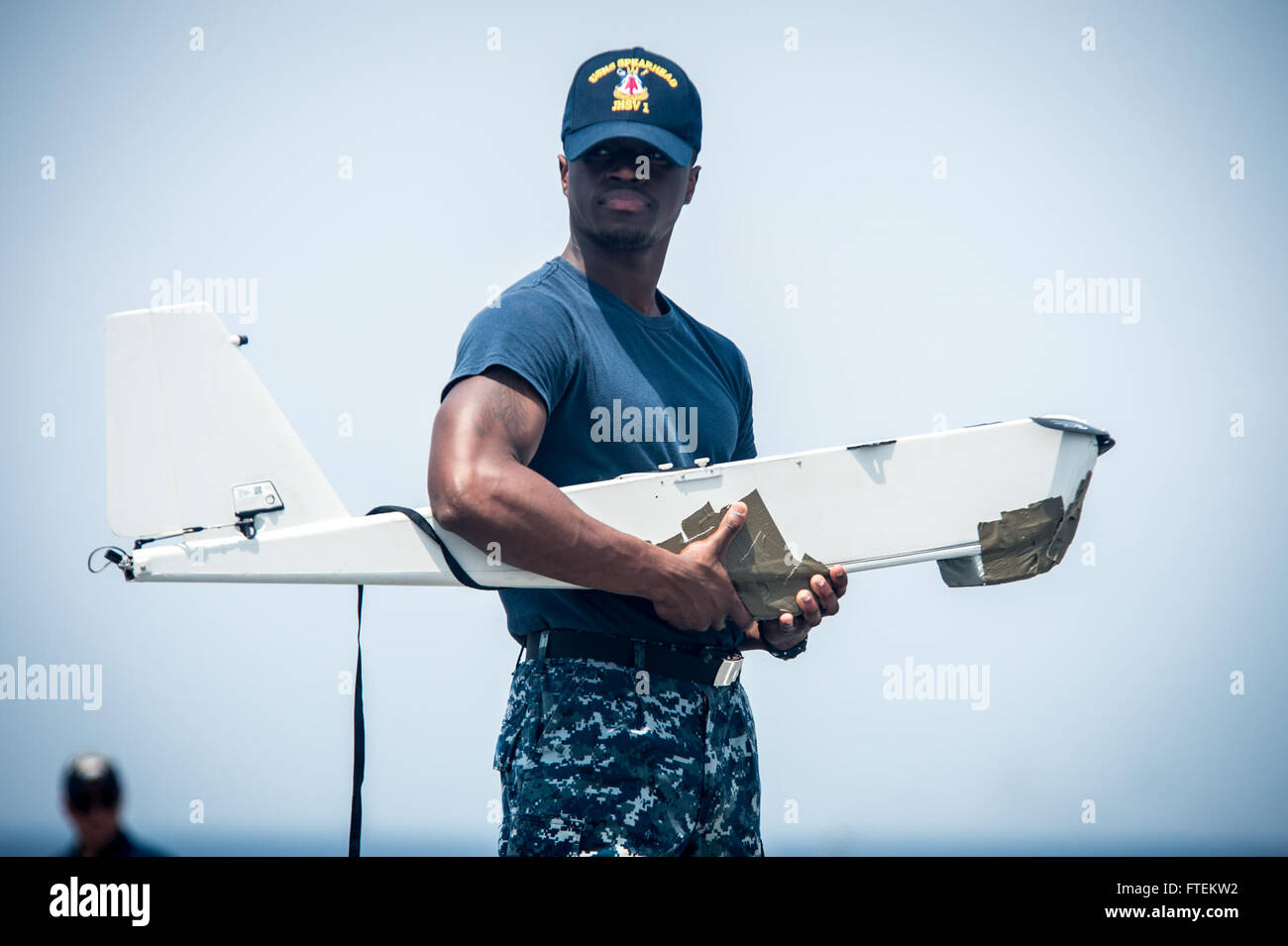 ATLANTIC OCEAN (Feb. 10, 2015) Information Systems Technician 3rd Class Marquise Simmons, from Summerville, South Carolina,  prepares an RQ-20A  Aqua Puma small unmanned aircraft system for launch aboard the Military Sealift Command’s joint high-speed vessel USNS Spearhead (JHSV 1) Feb. 10, 2015. Spearhead is on a scheduled deployment to the U.S. 6th Fleet area of operations to support the international collaborative capacity-building program Africa Partnership Station (APS). (U.S. Navy photo by Mass Communication Specialist 2nd Class Kenan O’Connor/Released) Stock Photo