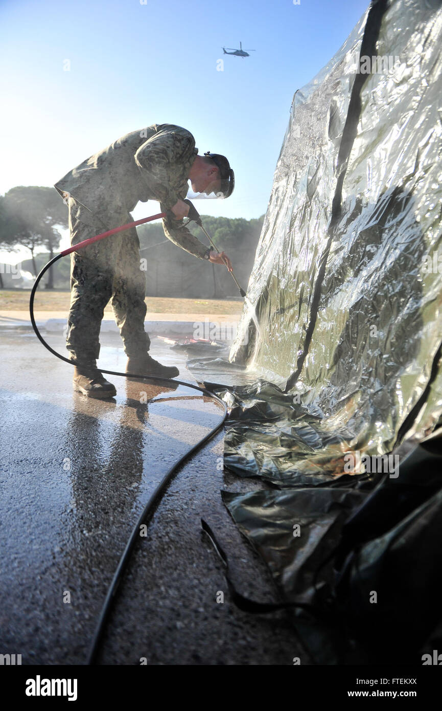 NAVAL STATION ROTA, Spain (Feb. 13, 2015) Utilitiesman 2nd Class Jason Noel, assigned to Naval Mobile Construction Battalion (NMCB) 11, pressure washes tents Feb. 13, 2015. NMCB 11 is currently deployed to 14 different detachment sites throughout European Command, African command, Pacific Command and Central Command; promoting security and stability by conducting general engineering, disaster relief, construction readiness operations and Human civic action support. (U.S. Navy photo by Mass Communication Specialist 1st Class Michael C. Barton/ Released) Stock Photo