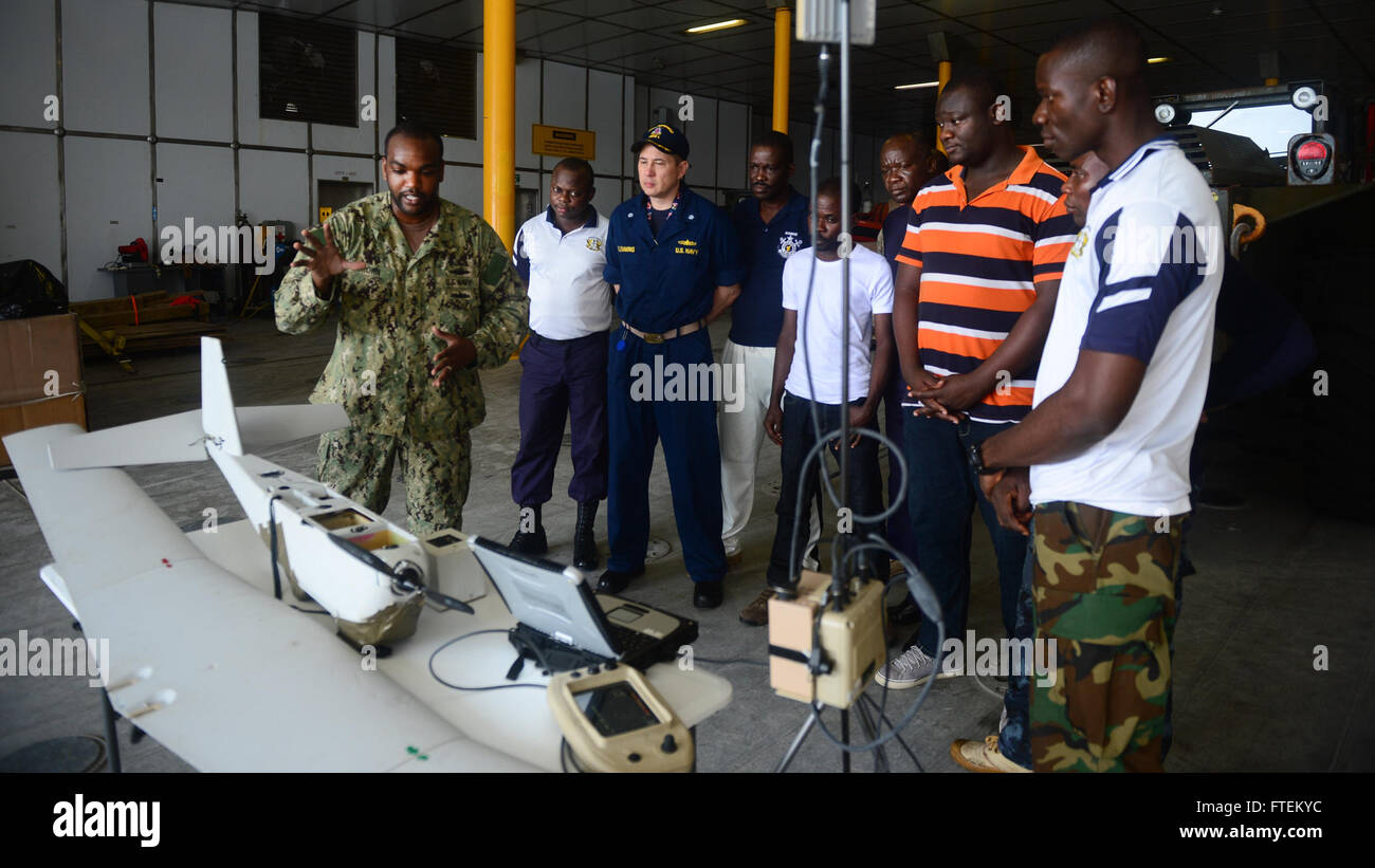 ATLANTIC OCEAN (Feb. 13, 2015) Chief Operations Specialist Dwayne Brown, from New York City, discusses the capabilities of the RQ-20A Aqua Puma small unmanned aircraft with embarked Ghanaian military personnel aboard the Military Sealift Command's joint high-speed vessel USNS Spearhead (JHSV 1) Feb. 13, 2015. Spearhead is on a scheduled deployment to the U.S. 6th Fleet area of operations in support of the international collaborative capacity-building program Africa Partnership Station. (U.S. Navy photo by Mass Communication Specialist 1st Class Joshua Davies/Released) Stock Photo