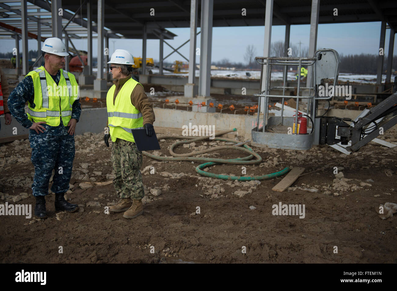 Romania (Feb. 19, 2015) Commander, Naval Facilities Engineering Command Chief of Civil Engineers Rear Adm. Katherine L. Gregory follows Naval Support Facility (NSF) Deveselu Executive Officer Cmdr. Rod Tribble during a tour of the ongoing construction of permanent facilities at NSF Deveselu Feb. 19, 2015. NSF Deveselu is Navy Region Europe Africa Southwest Asia’s latest tool for providing efficient and effective shore service support to United States and Allied Forces operating in Europe, Africa and Southwest Asia. Gregory’s visit included a tour of the temporary f Stock Photo